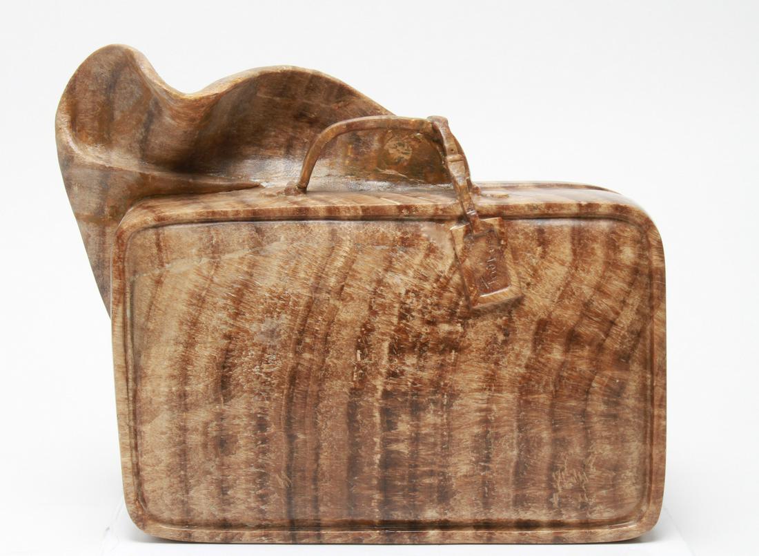 Thea Tewi Briefcase Modern Carved Stone Sculpture: Thea Tewi (German-American, 1902-1999) "Briefcase," carved stone sculpture depicting briefcase with sheet / clothing sticking out, signed and dated on tag "Tewi 1986," with acrylic display case / cove