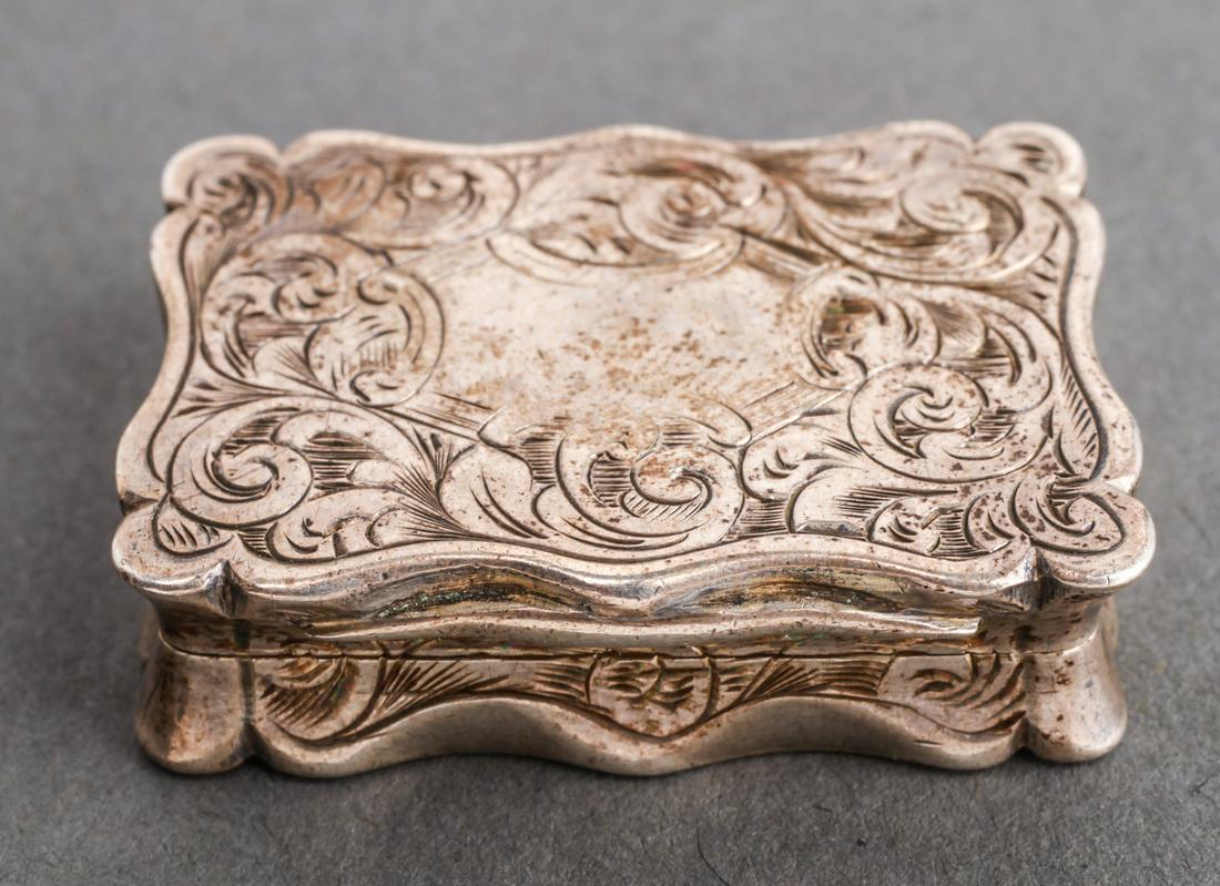 English Sterling Silver Engraved Vinaigrette 1867: English sterling silver engraved vinaigrette, an interior hinged engraved gilt-silver pierced grille, gold-washed interior, hallmarked: "RT / Birmingham / England / 1867," 19th century. 0.375" H x 1.3