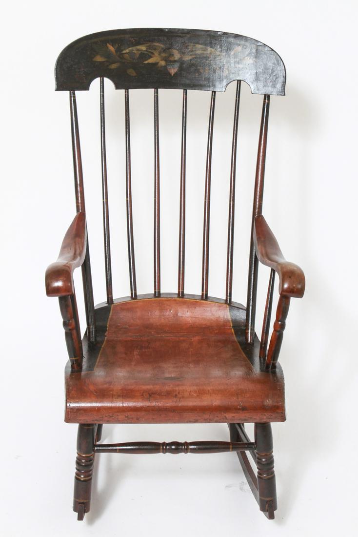 Spindle Back Rocking Arm Chair w Stenciled Eagle: Spindle back rocking arm chair with stenciled crest depicting eagle, painted finish. 42" H x 22.5" W x 29" D. Minor age cracks, surface wear and abrasions.