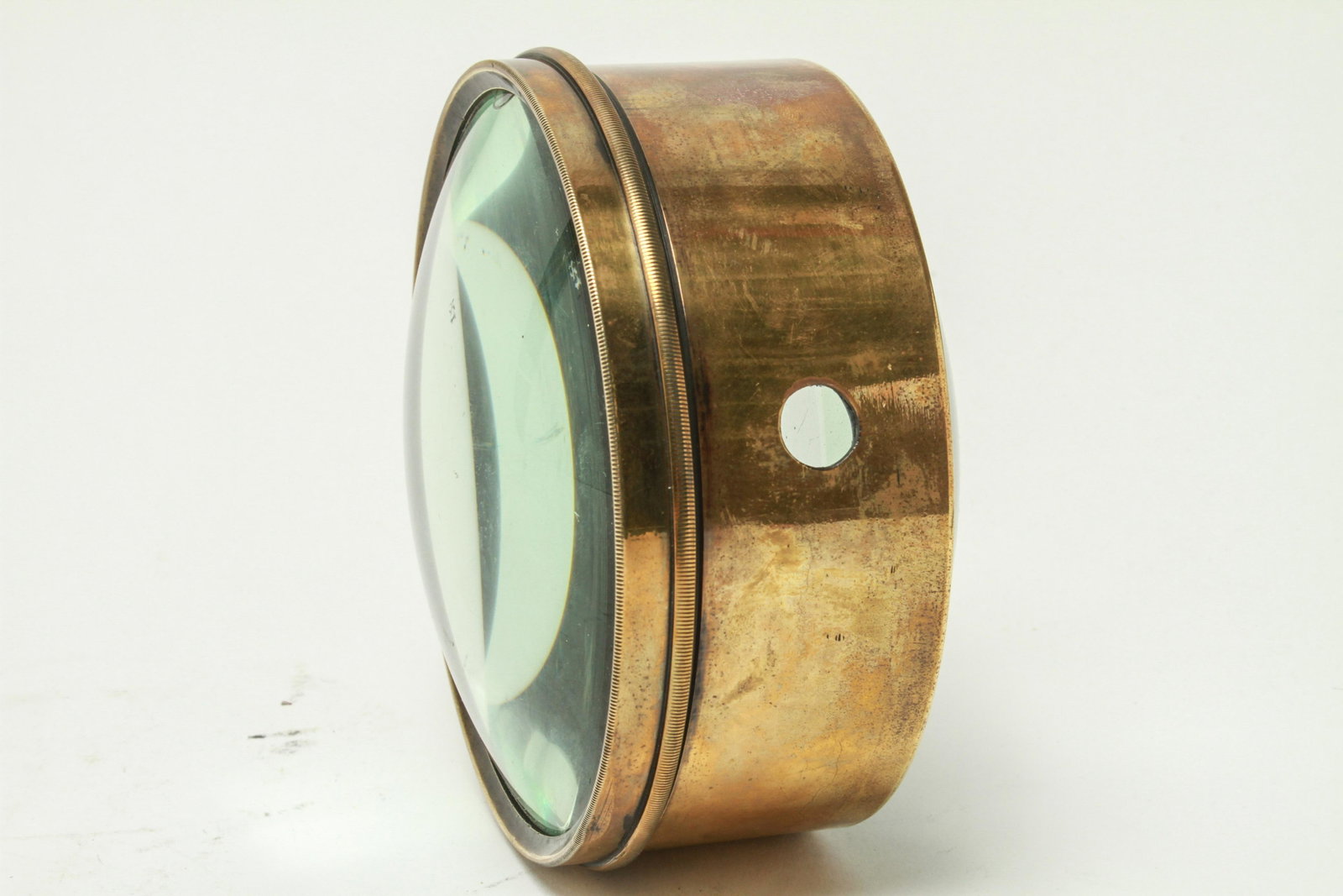 English Nautical Chart Magnifying Lens w Brass: English nautical chart lens / double magnifying lens, with brass collar mount. 3" H x 5.75" diameter. Minor repaired chip at edge.
