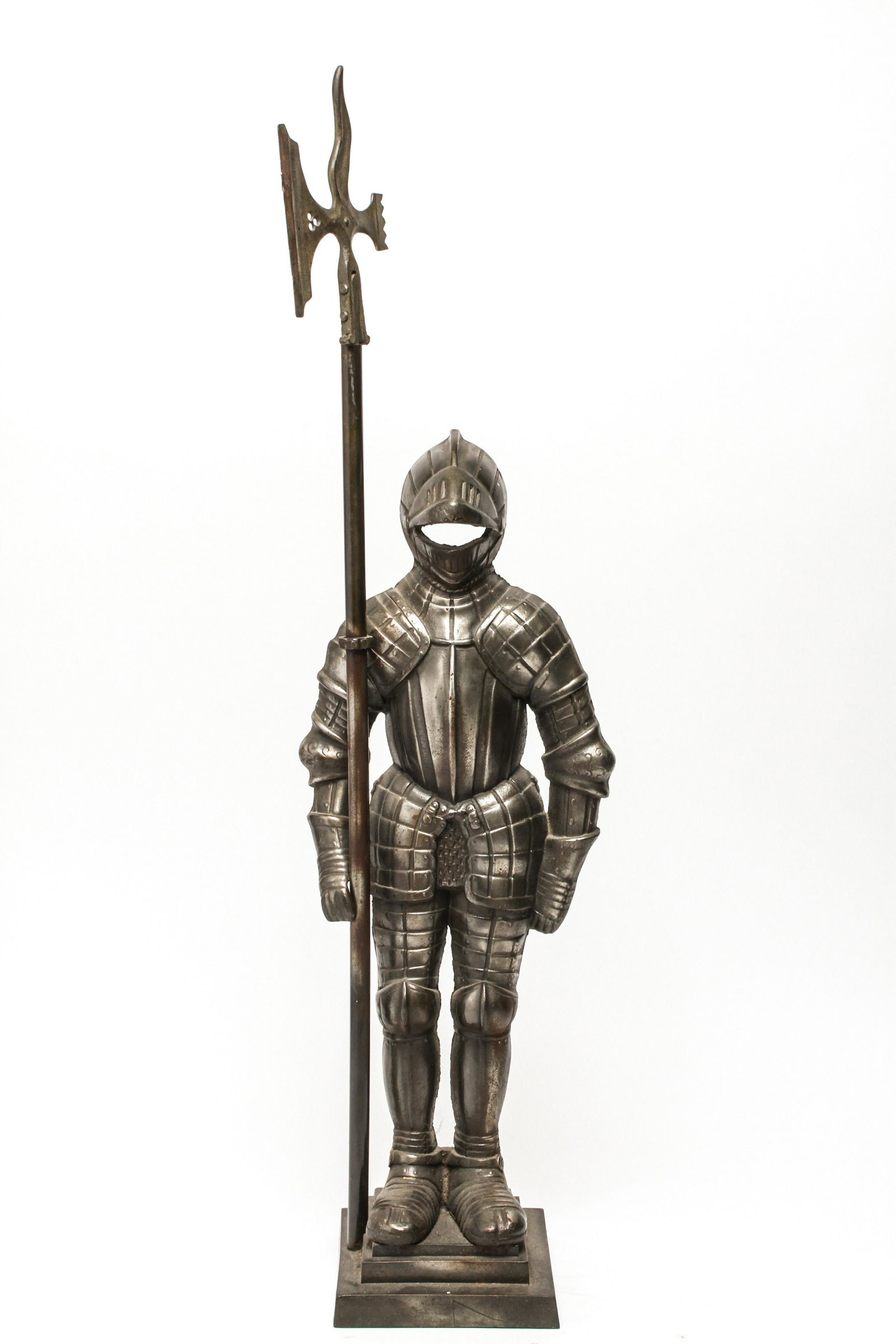 Nestor England Knight Fireside Metal Sculpture: Nestor England knight in suit of armor fireside sculpture with removable halberd axe on a stepped base, cast-metal, marked, "Nestor / Made in England." 36.25" H x 9.75" W x 6.5" D.