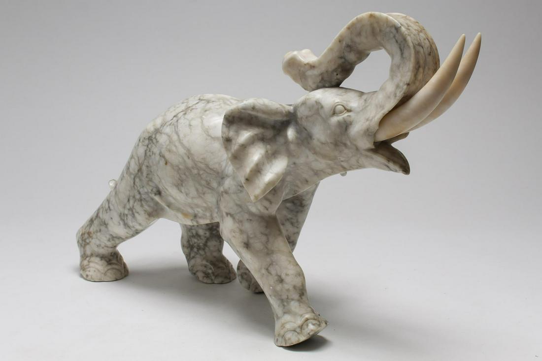 Elephant Figure, Carved Marble w. Alabaster Tusks: Elephant sculpture, carved white and gray marble with removable alabaster tusks. 12.75" H X 17.5" W. One tusk with screw end restored; breaks and losses to both tusk inset holes.