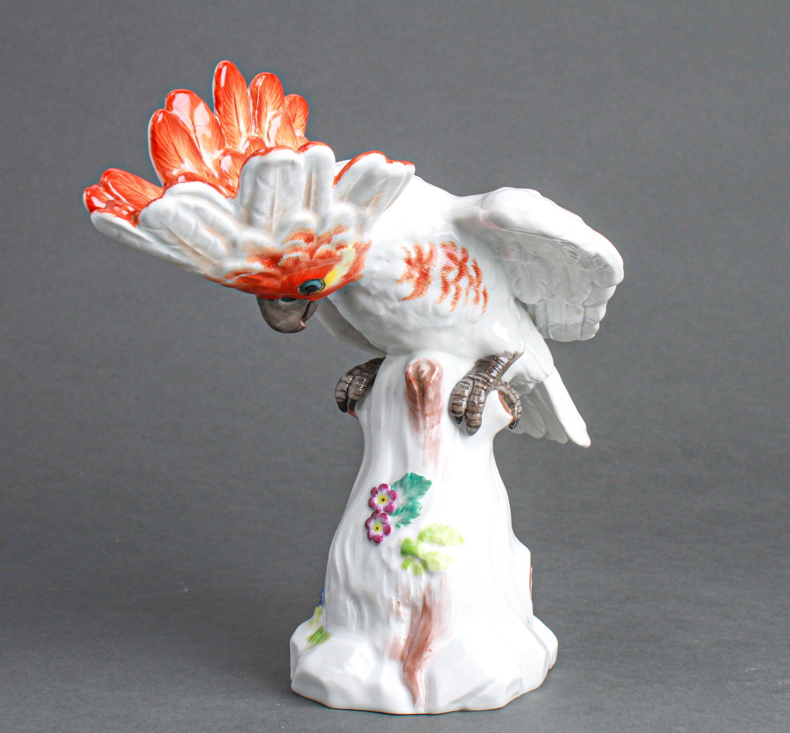 Meissen Cockatoo Porcelain Figurine Sculpture: Meissen hand painted porcelain cockatoo figurine sculpture, probably 20th century, marked with Meissen under-glazed blue crossed swords. 9" H x 9" W x 6" D.