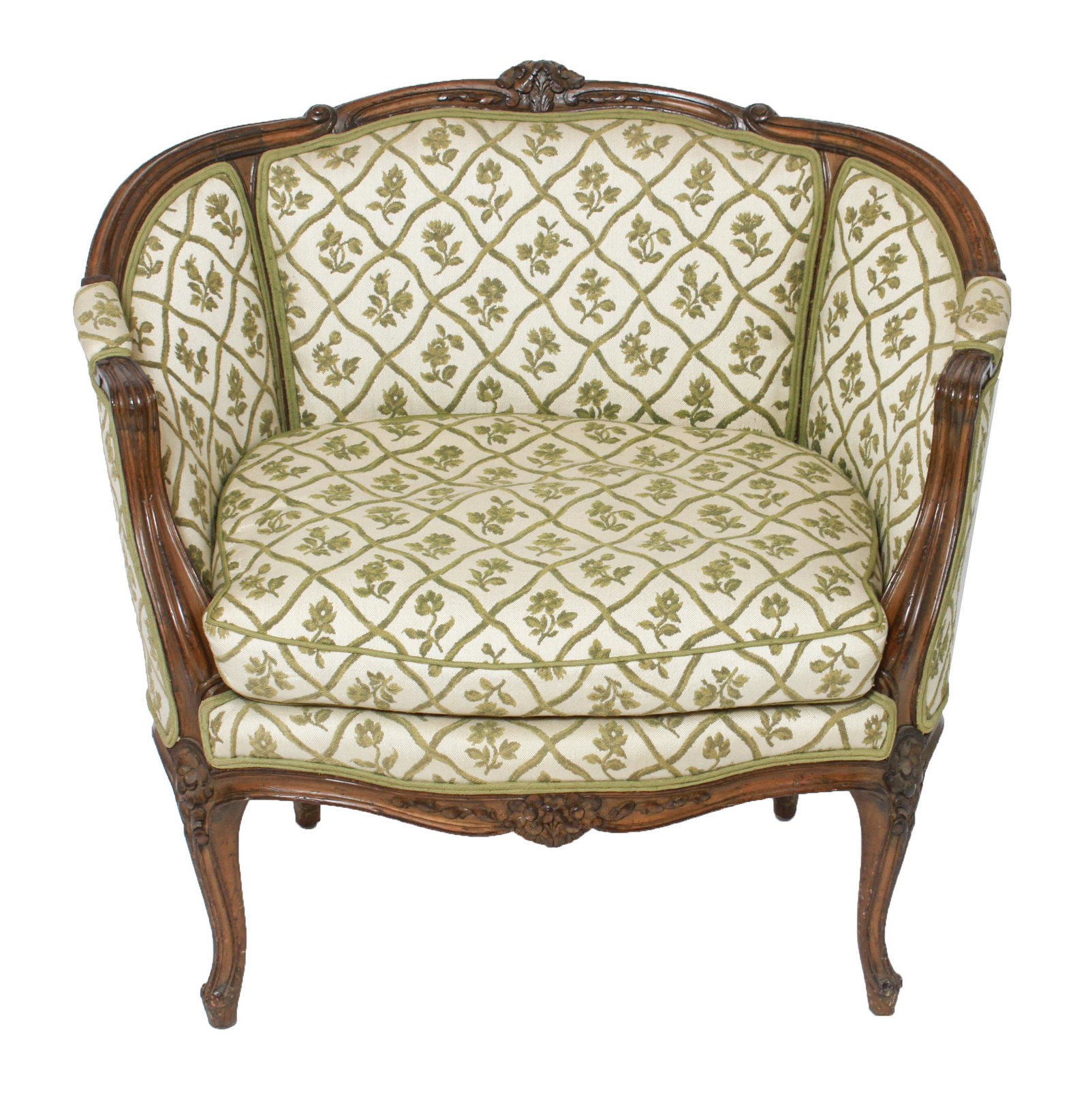 French Louis XV Style Oversize Bergere / Armchair: French Louis XV style oversize carved wood and upholstered bergere / arm chair, extra wide, floral carved crest and cabriole legs, foliate motif upholstery. 32.75" H x 36" W x 28" D.