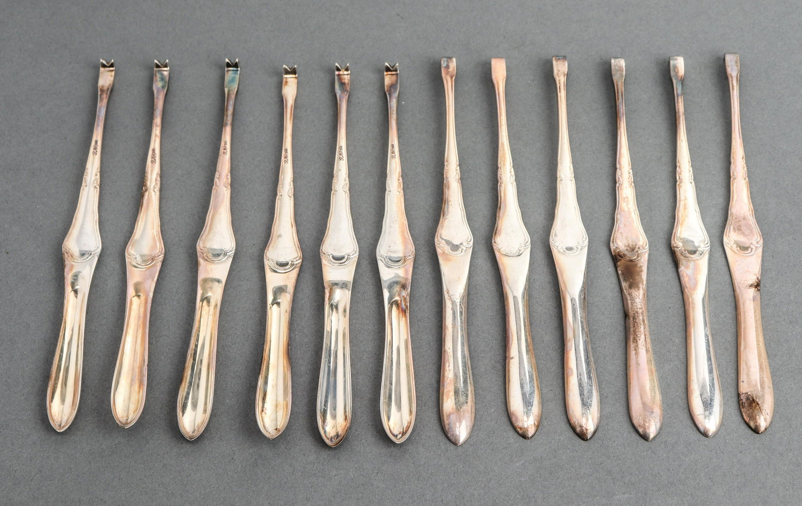 German Silver Marrow Scoop Set, 12: Set of 12 German silver bone marrow scoops with scraping tool at opposite end, hallmarked and marked "800." 7.5" L. Approx: 11.65 ozt.