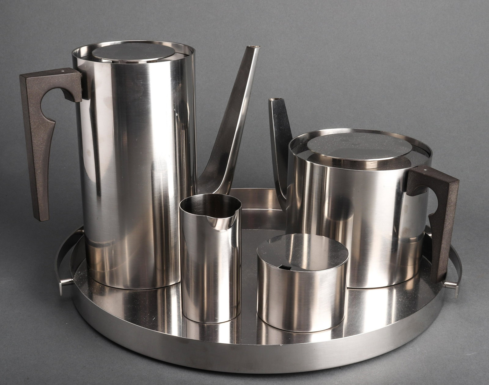Jacobson for Stelton Lauffer “Cylinda” Coffee Set: Stelton Lauffer “Cylinda” brushed steel coffee and tea service, designed by Arne Jacobson, comprising a coffee pot and lid, a teapot and lid, a cream jug/pitcher, a sugar bowl and lid, and a two-h