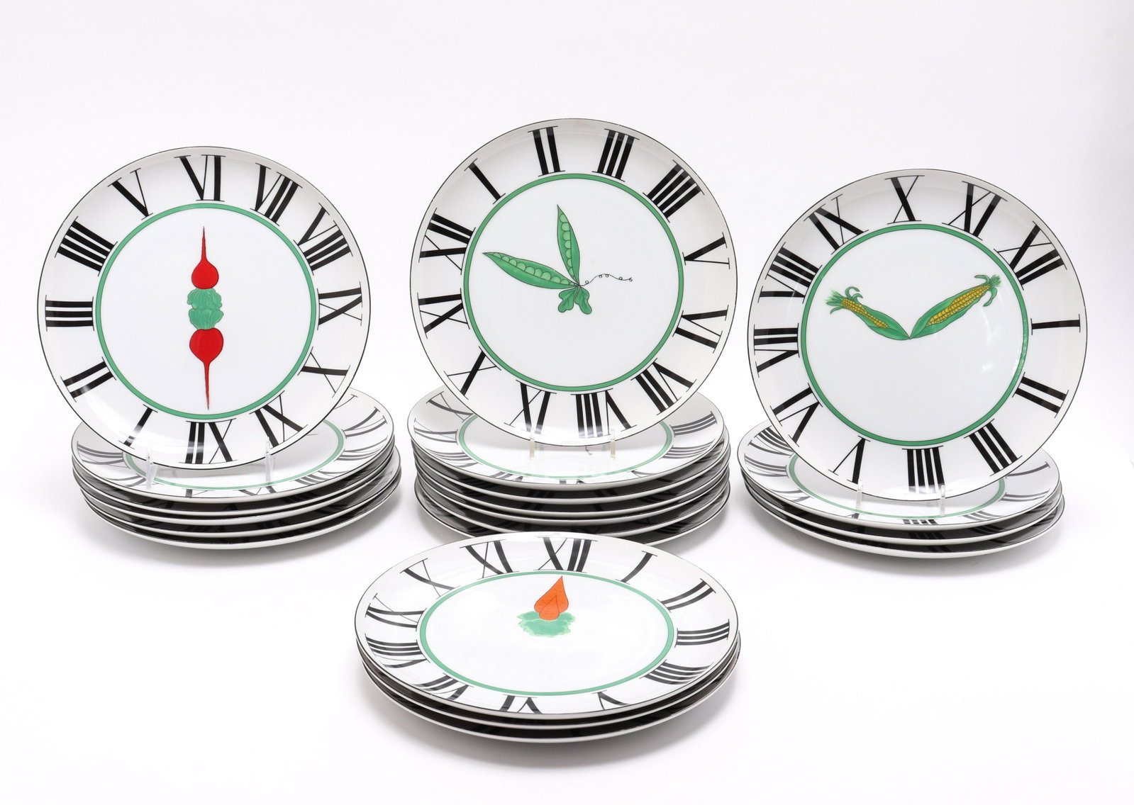Taste Seller "Time To Dine" Porcelain Plates, 20: Taste Seller by Sigma "Time to Dine" porcelain plates, set of 20, clock face motif with black Roman numerals and various vegetables including corn, peas, carrots, and radishes, marked on reverse "Fran
