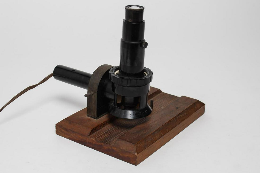 Vintage Magnifier E.W. Pike Flash-O-Lens, 1920s: Illuminating magnifier, vintage 1920s plug-in model tool, in a wood stand for ease of use. Overall: 7.75" H X 8.25" W.