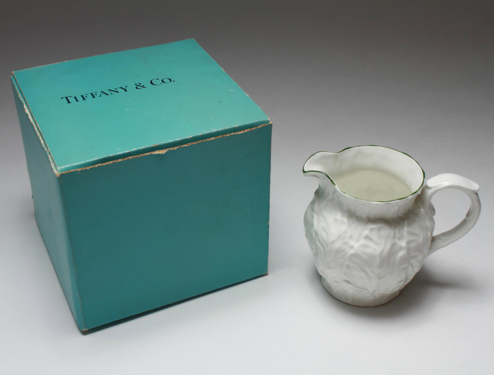 Tiffany Coalport "Countryware" Bone China Milk Jug: Tiffany & Co. Coalport "Countryware"-pattern bone china milk jug with a pattern of overlapping embossed leaves, the mouth trimmed with green stripe, the underside with stamped factory marks, in the or