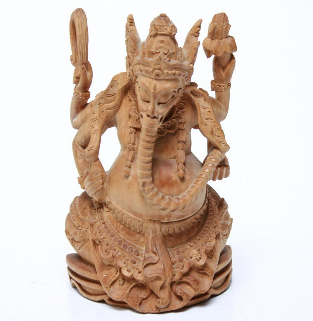 Balinese Carved Sandalwood Ganesh Figurine: Balinese or Indonesian carved sandalwood figurine of a seated Ganesh with four arms and elaborate headdress. 6.5" H.