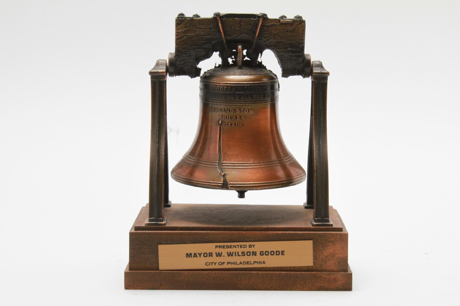 Liberty Bell Cast Metal Presentation Statue: Liberty bell cast metal presentation statue mounted to wooden base with plaque inscribed "Presented by Mayor W. Wilson Goode City of Philadelphia." 7.5" H x 6.25" W x 4" D.