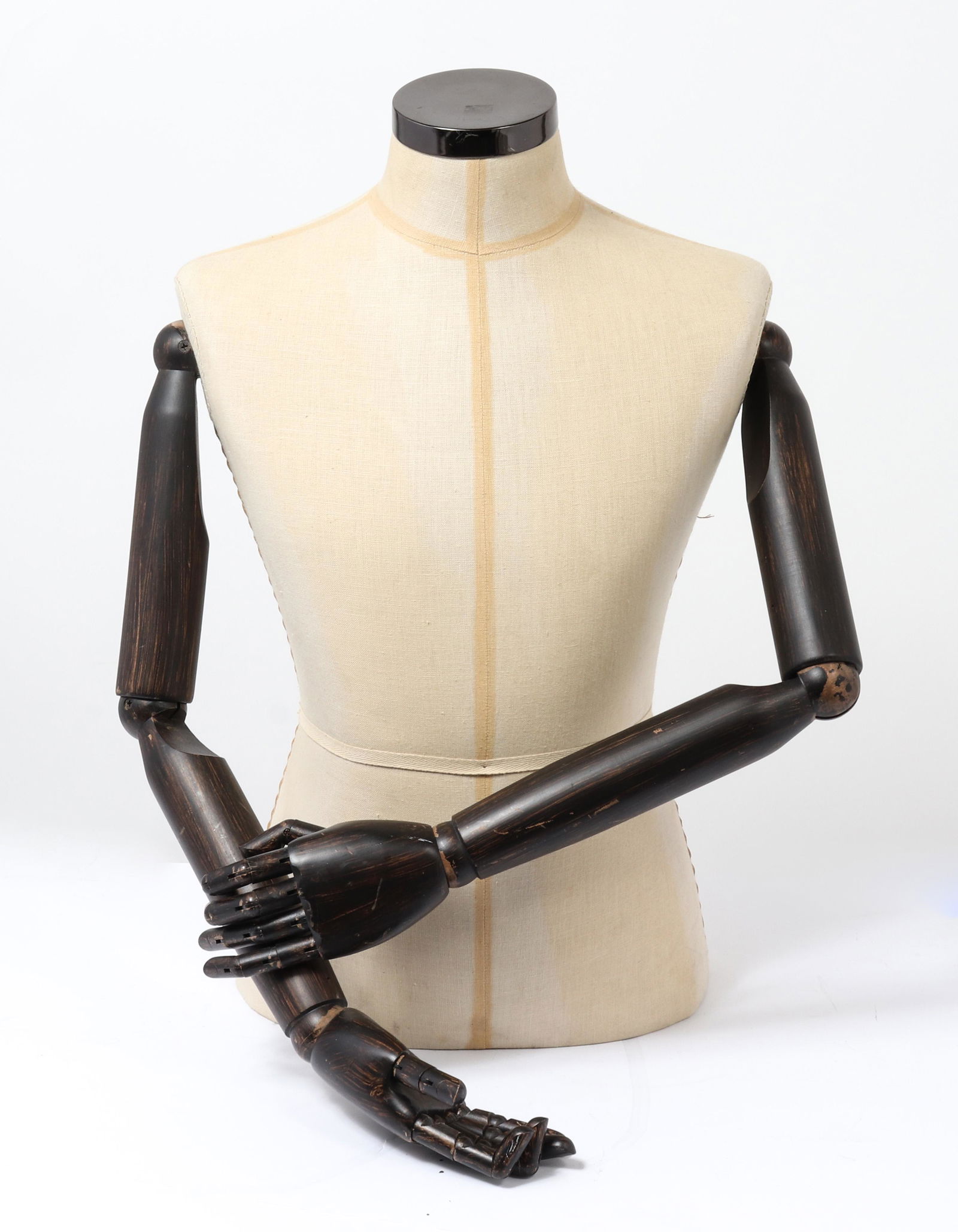 Burberry Fashion Mannequin with Articulated Arms: Burberry fashion mannequin torso, fabric lined body, carved wood arms and hands with articulated joints and fingers, logo on reverse marked: "Burberry Established 1856." 26" H.