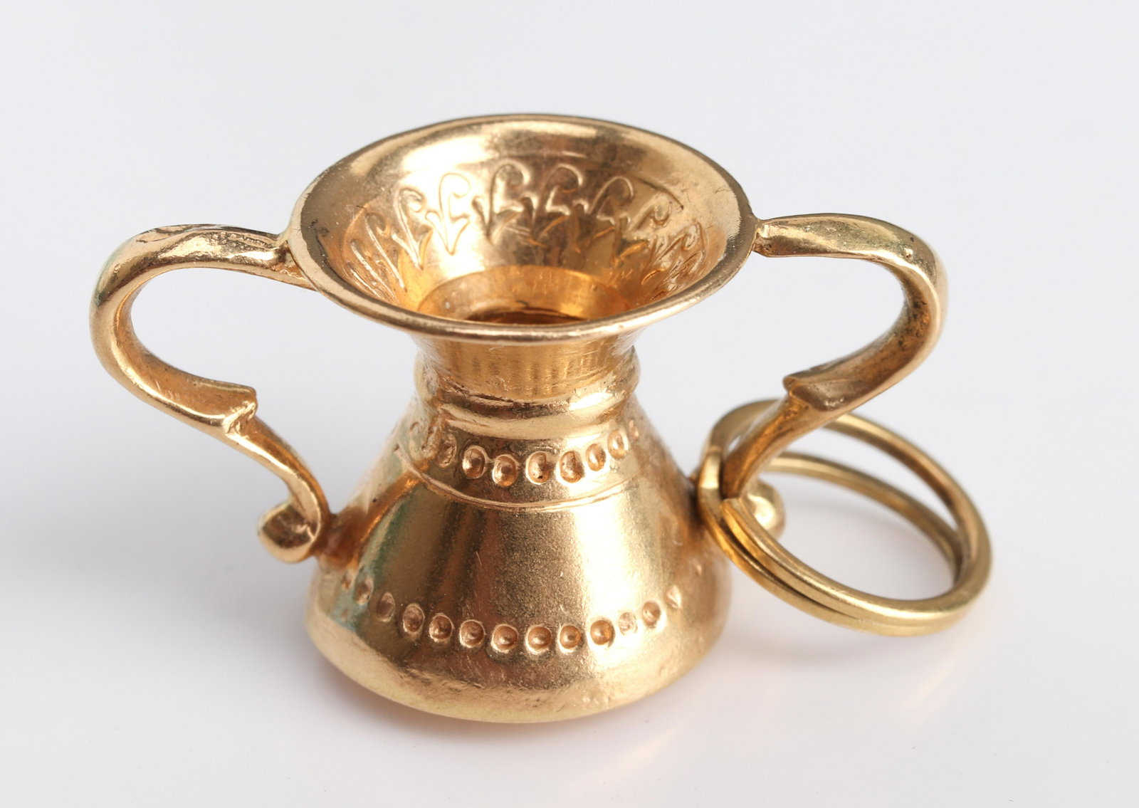 Antique 18K Yellow Gold Double Handle Goblet Charm: Antique 18K yellow gold double handle goblet charm, marked: "750" with maker's mark. 1.25" L x 1.0" W x 0.5" H. Approx: 2.2 dwt.