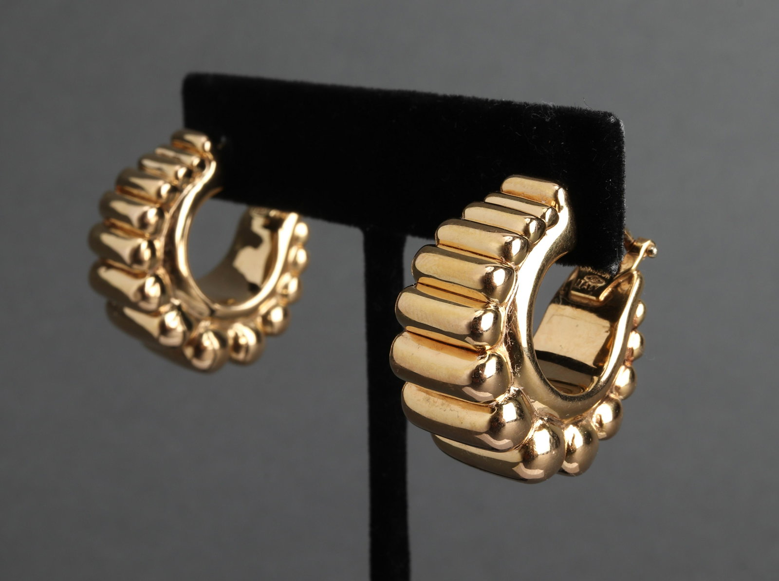 Milor Italian 14K Yellow Gold Puff Hoop Earrings: Milor Italian 14K yellow gold ribbed puff hoop post earrings with omega backs, marked: "MILOR / 585 / ITALY." 1.0" L x 0.5" W (at widest section). Approx: 6.6 dwt.