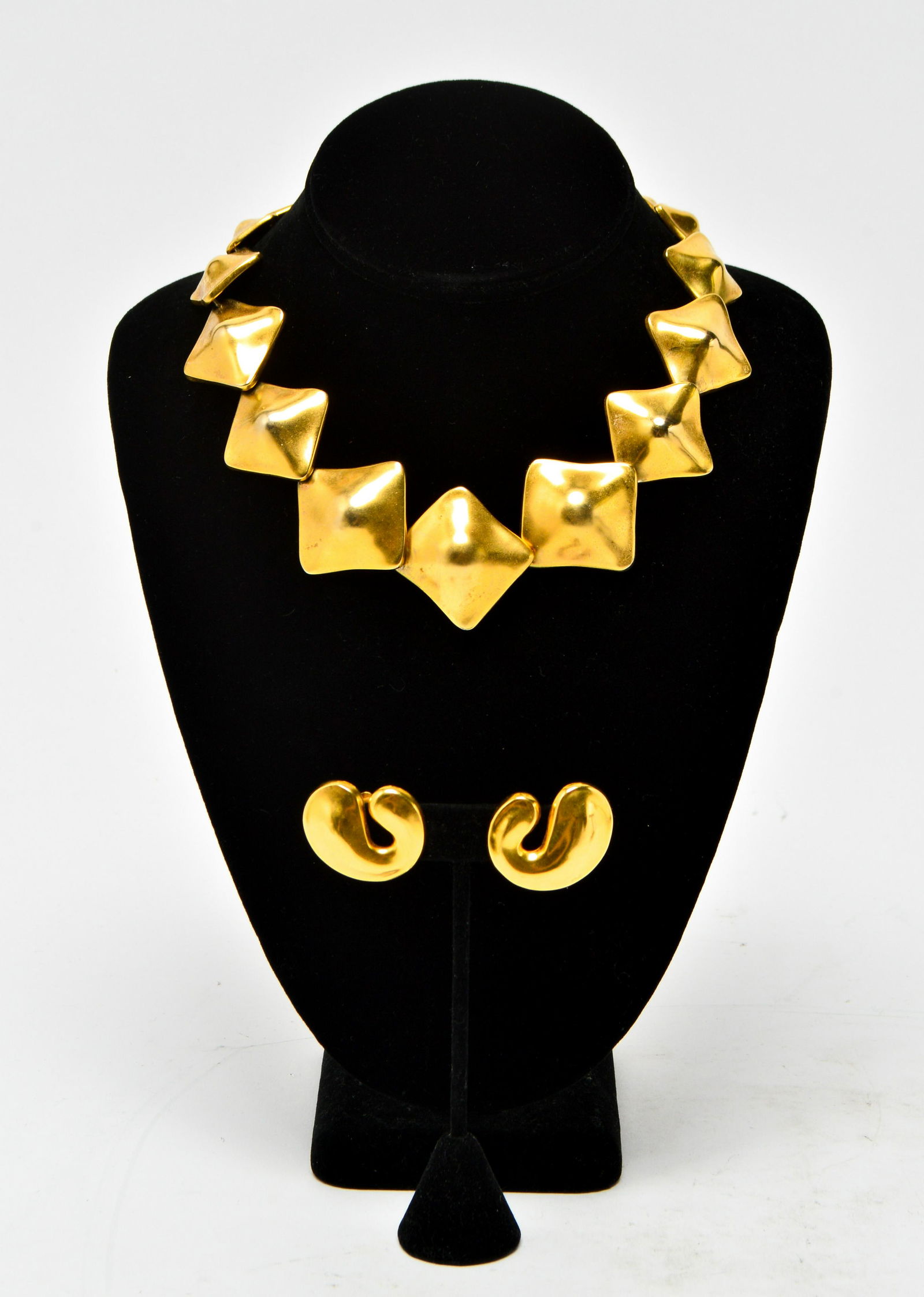 Robert Lee Morris Modern Necklace & Earrings, Two: Robert Lee Morris Modern gold-tone costume jewelry, lot comprising of one necklace with square stud-form motif and biomorphic form clip on earrings. Necklace: 16" L; earrings: 1" L x 1" W.