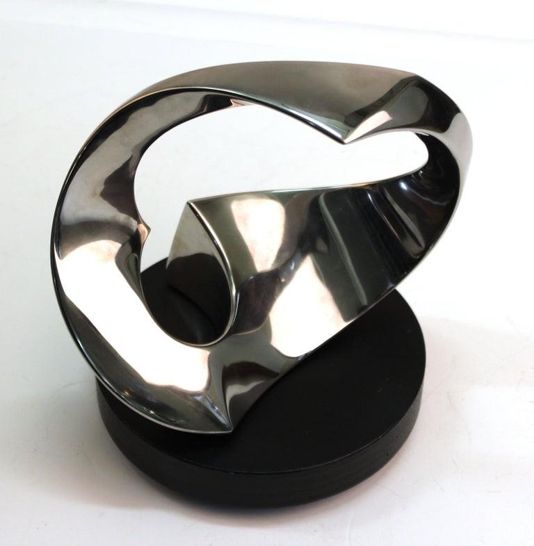Todd Reuben Modern Abstract Metal Sculpture: Todd Reuben modern abstract metal sculpture of twisting form, mounted on rotating base, marked "Sculpture 56," marked on the base "Sculpture 56 - Todd Reuben - 9 6 96." 10" H x 10" diameter.
