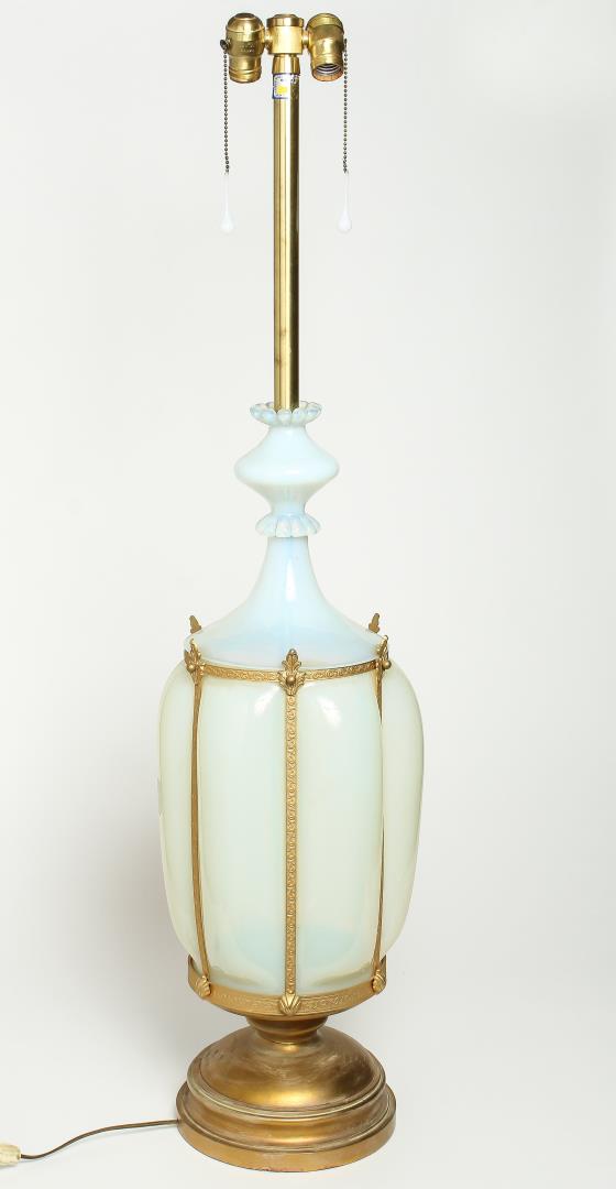 Monumental Murano Opalescent Glass Lamp: Monumental Murano opalescent glass table lamp, the whitish body in a foliate-stamped ormolu cage, mounted on gilt metal base. 56" H. Finial replaced.