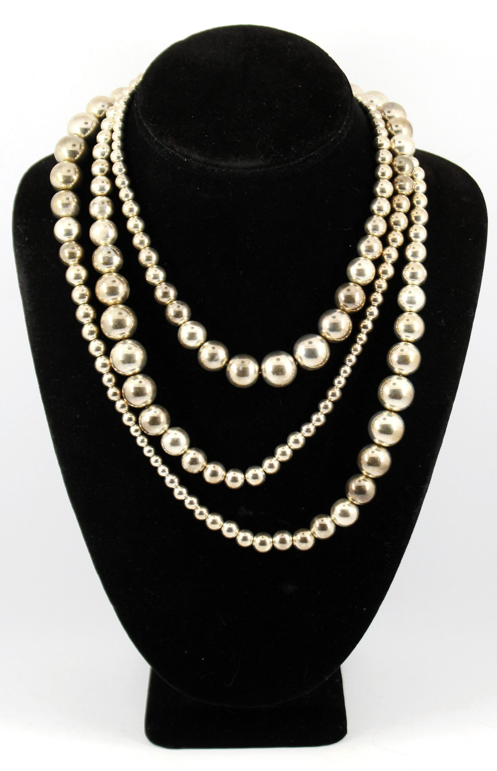 Robert Lee Morris Studio Silver Graduated Necklace: Robert Lee Morris Studio silver graduated bead rope-length necklace with lobster claw clasp. Marked "RLM / Studio." Silver tested. Beads arranged with five sections of increased size from 5mm to 13mm.