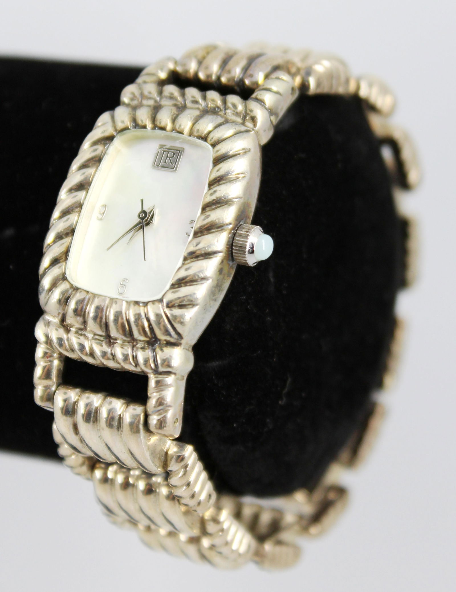 Judith Ripka Sterling Silver Watch: Judith Ripka sterling silver ladies' watch / wristwatch, quartz, Japan movement, mother-of-pearl dial, stainless steel backing, sterling silver case and bracelet. 7.5" L. Silver not weighable.