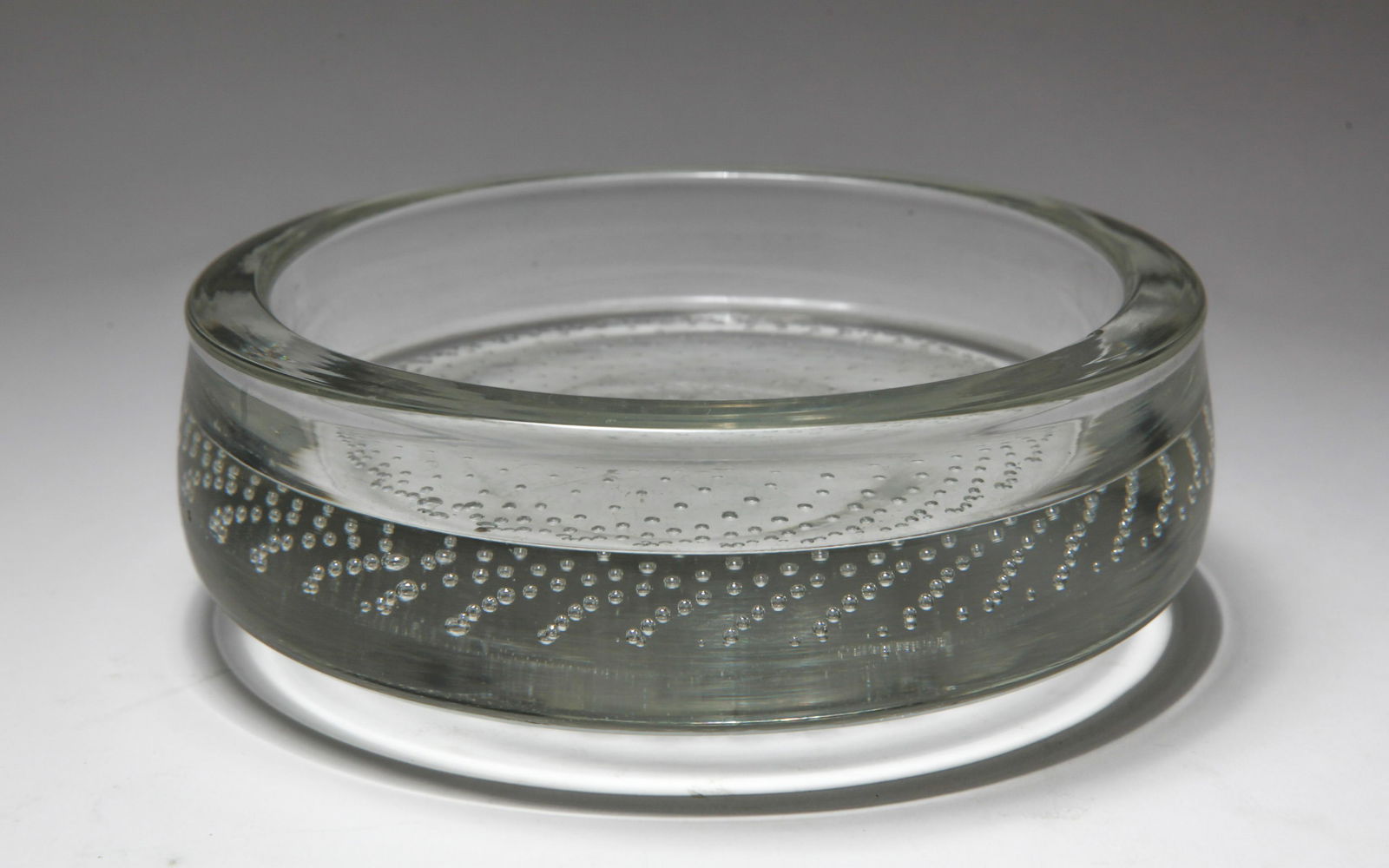 'Bullicante' Glass Bottle Coaster: 'Bullicante' glass bottle coaster, unmarked. 2.25" H x 6.5" diameter. Chip to interior rim.