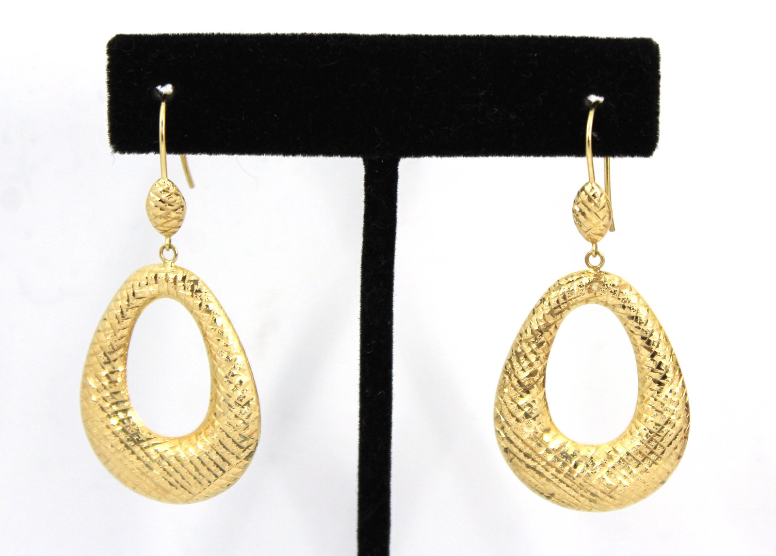 Jacmel Mauritius Designer 14K Yellow Gold Earrings: Modern Jacmel Mauritius designer 14K yellow gold hollow oval hoop dangle earrings with crosshatched surface design and French hook clasps, marked "JCM 14K." Drop 2" L. Approx: 2.1 dwt.