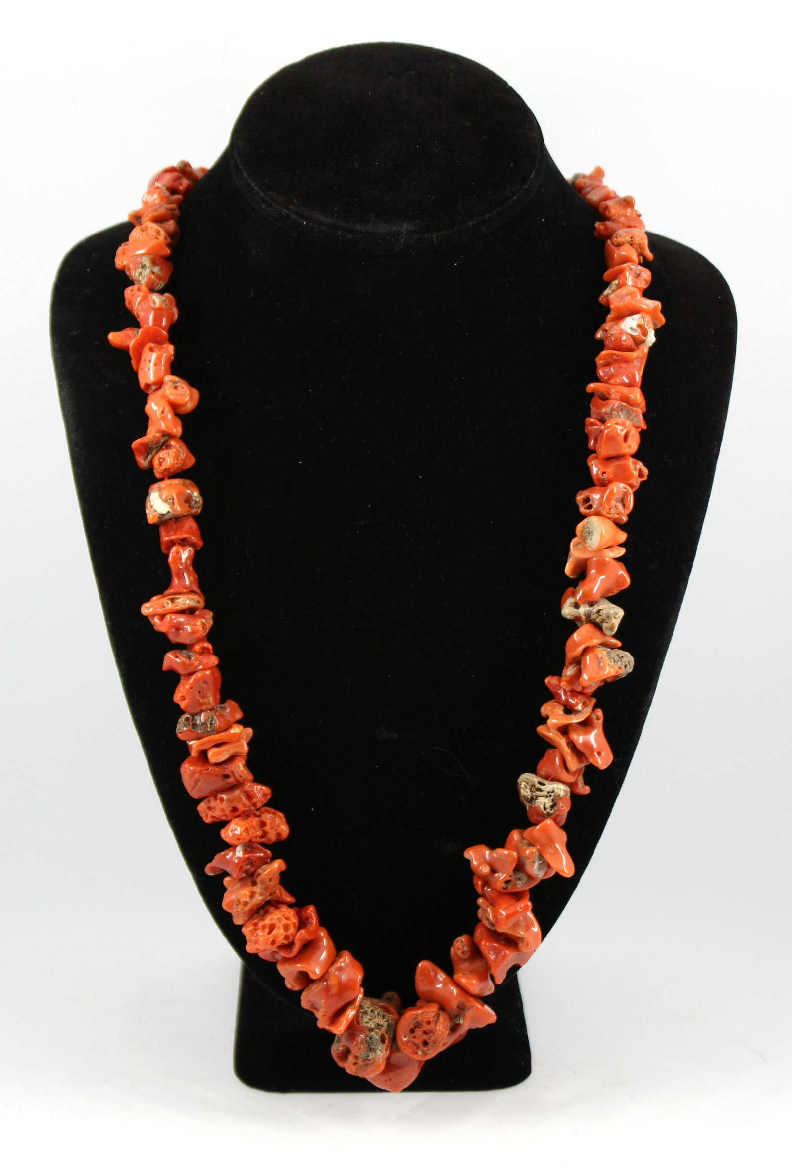 Vintage Les Bernard Graduated Coral Chunk Necklace: Vintage Les Bernard graduated coral chunk necklace with gold-tone barrel screw clasp. Bears a gold-tone tag marked "Les / Bernard / Inc." Coral chunk beads from 10mm wide at terminal to 20mm wide at c