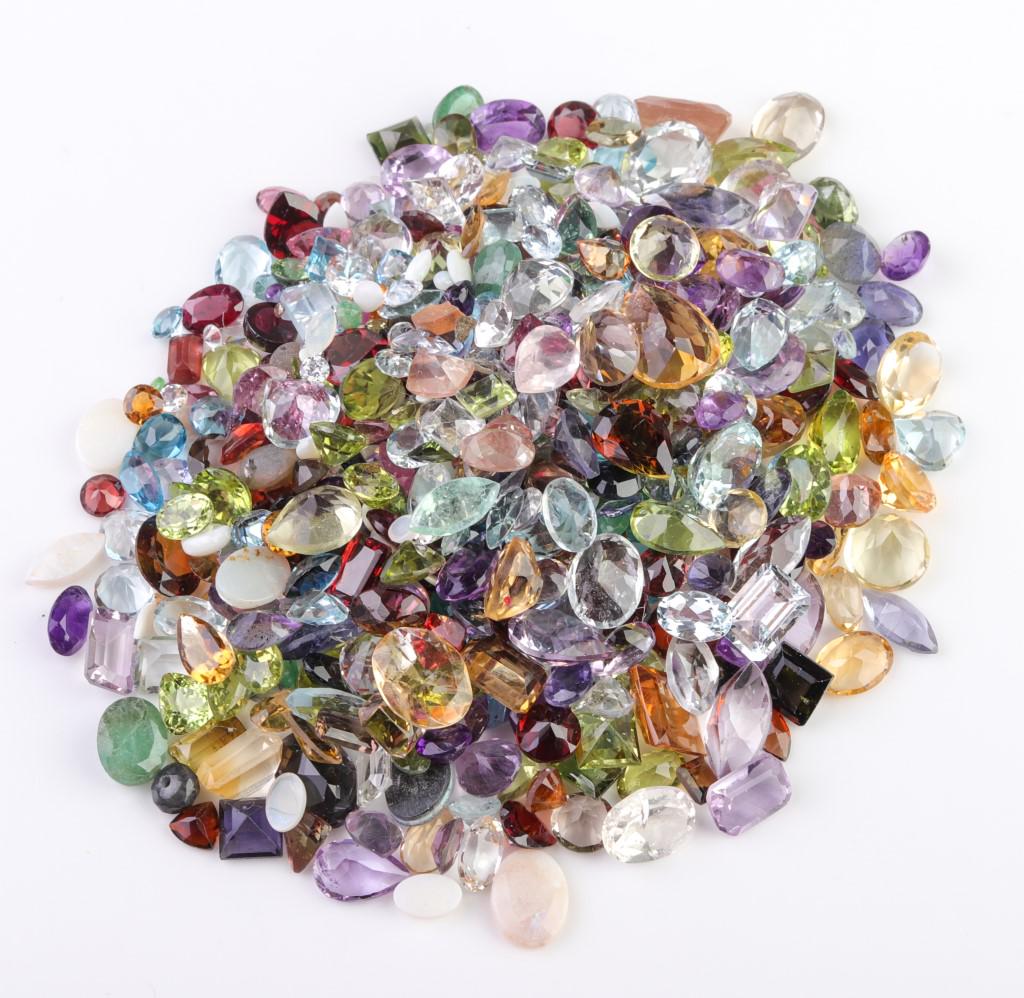250 cttw. Loose Mixed-Cut Multicolored Gemstones: 250 cttw. parcel of loose mixed-cut multicolored gemstones. Gemstones range in size from 12 mm to 1.5 mm. Some abraded stones.