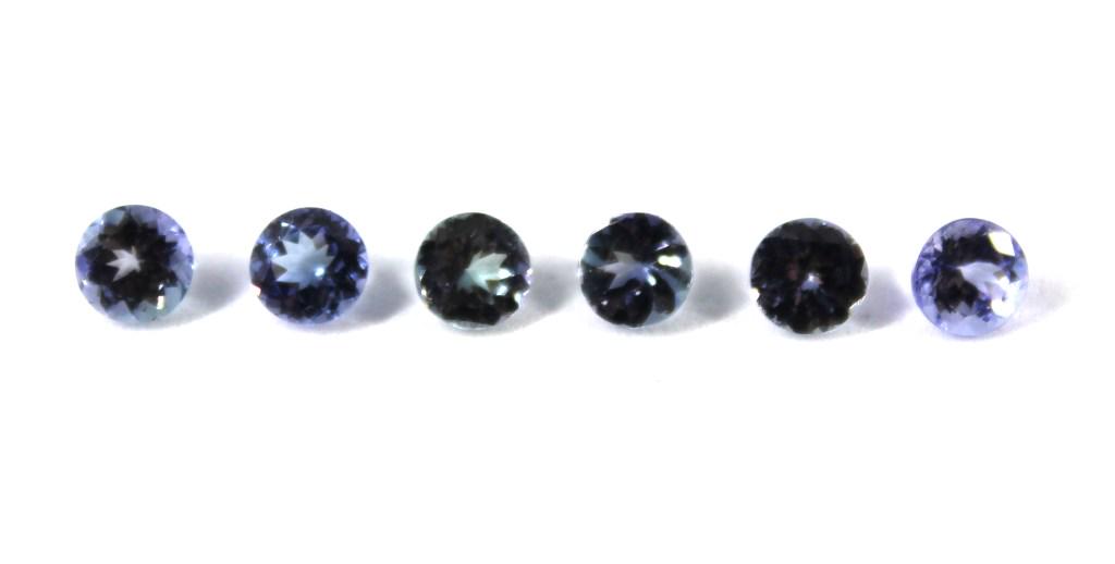 4.10 cttw. Loose Round-Cut Tanzanite Stones, 6: 4.10 cttw. collection of six loose round-cut faceted pinkish purple to sage greenish purple tanzanite stones. 5 mm x 5 mm each.