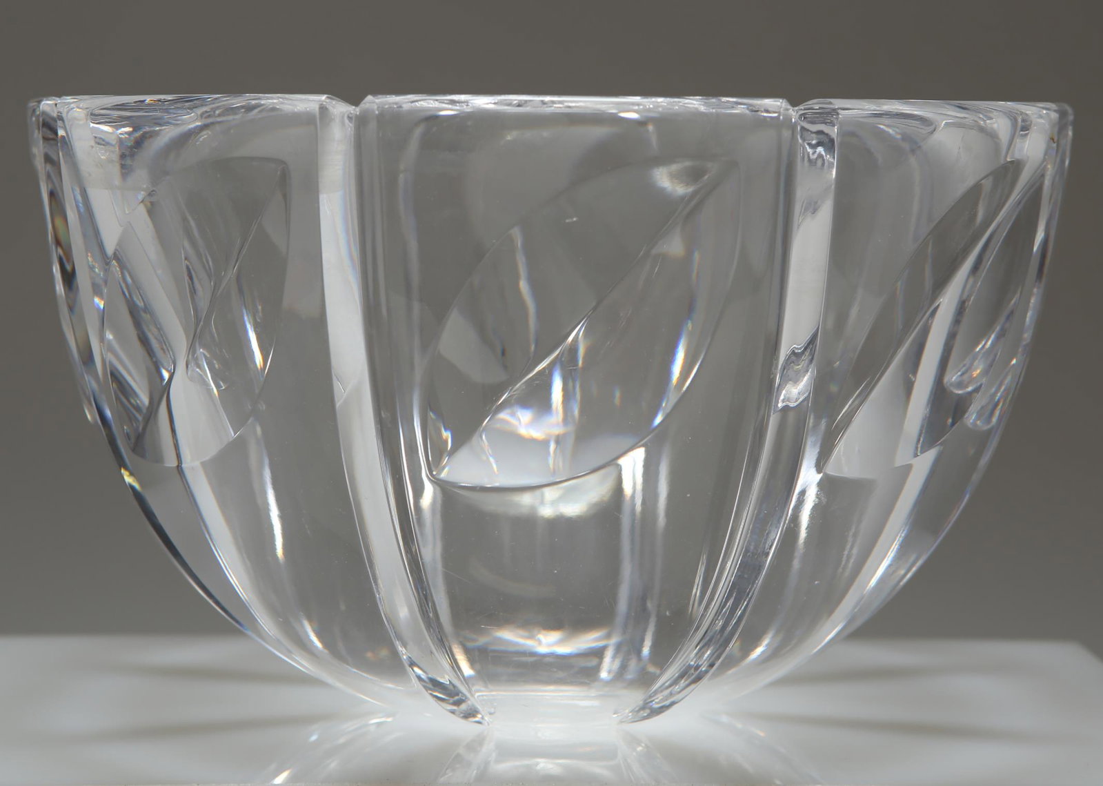 Orrefors Crystal "Ribbed Leaves" Bowl: Orrefors colorless crystal "Ribbed Leaves" bowl, the sides with notched vertical ribs interspersed with cut slanted leaves, underside signed "Orrefors 4707-13." 5" H x 8.5" diameter.