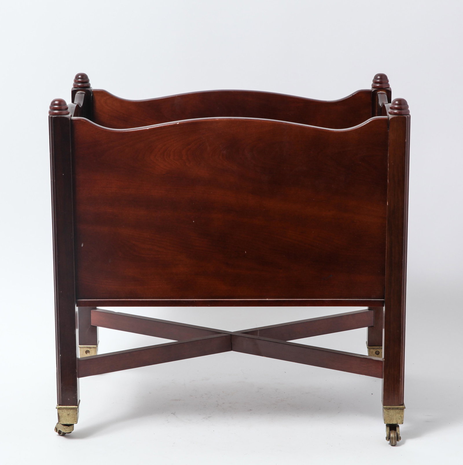 Georgian Manner Mahogany Canterbury: Georgian manner mahogany canterbury with two wells, openwork brass mounts, and X-form cross brace; on casters. 18.5" H X 18" L X 11.25" D.