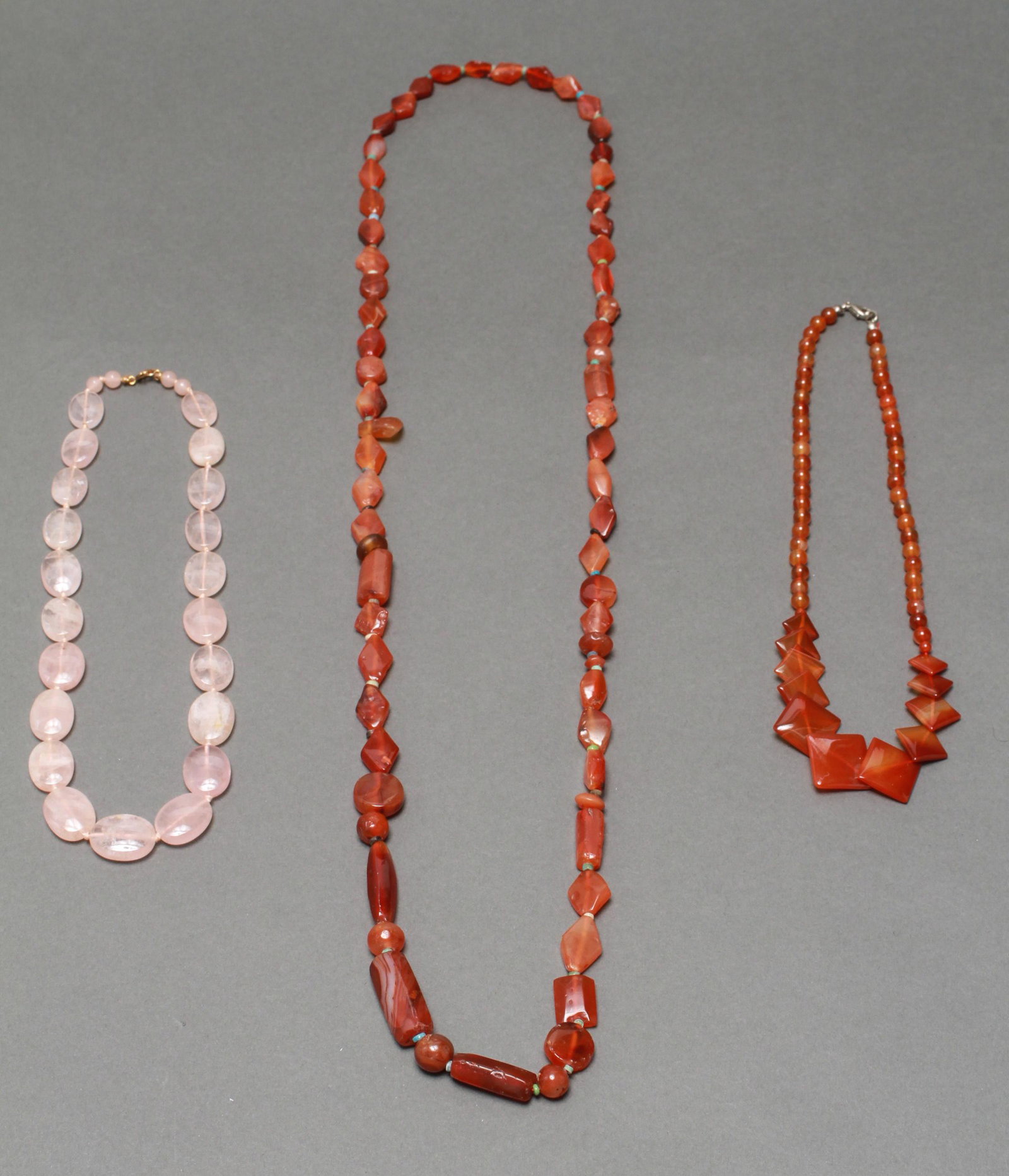 Carnelian & Rose Quartz Necklaces, 3: Group of three necklaces, two with carnelian agate beads, one with rose quartz beads. Longest: 19" L.