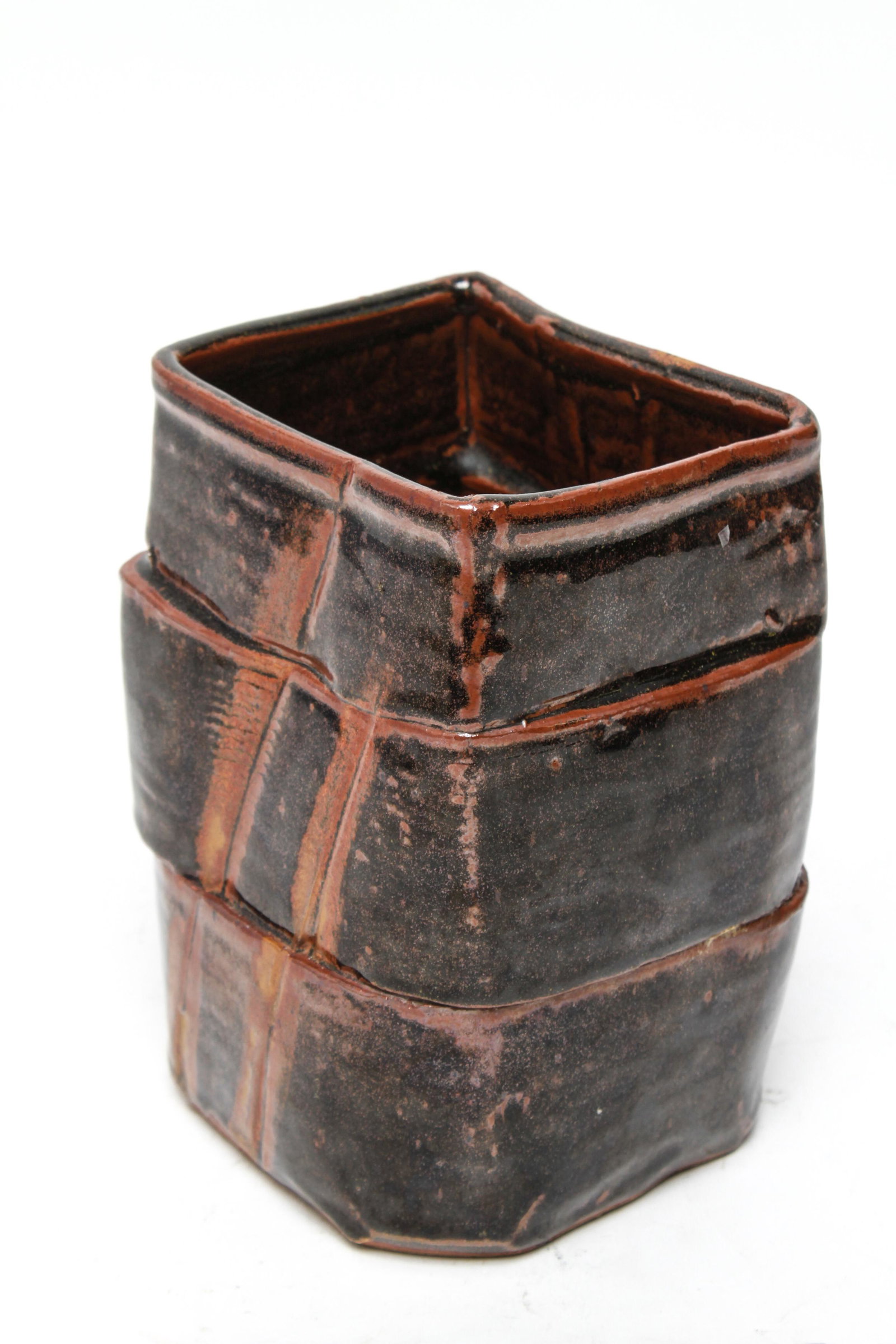Joan Platt Studio Art Pottery Vase: Joan Platt Studio art pottery vase in chocolate brown and burnt umber glazes, the underside incised by the artist. 7" H x 4.5" W x 3.5" D.