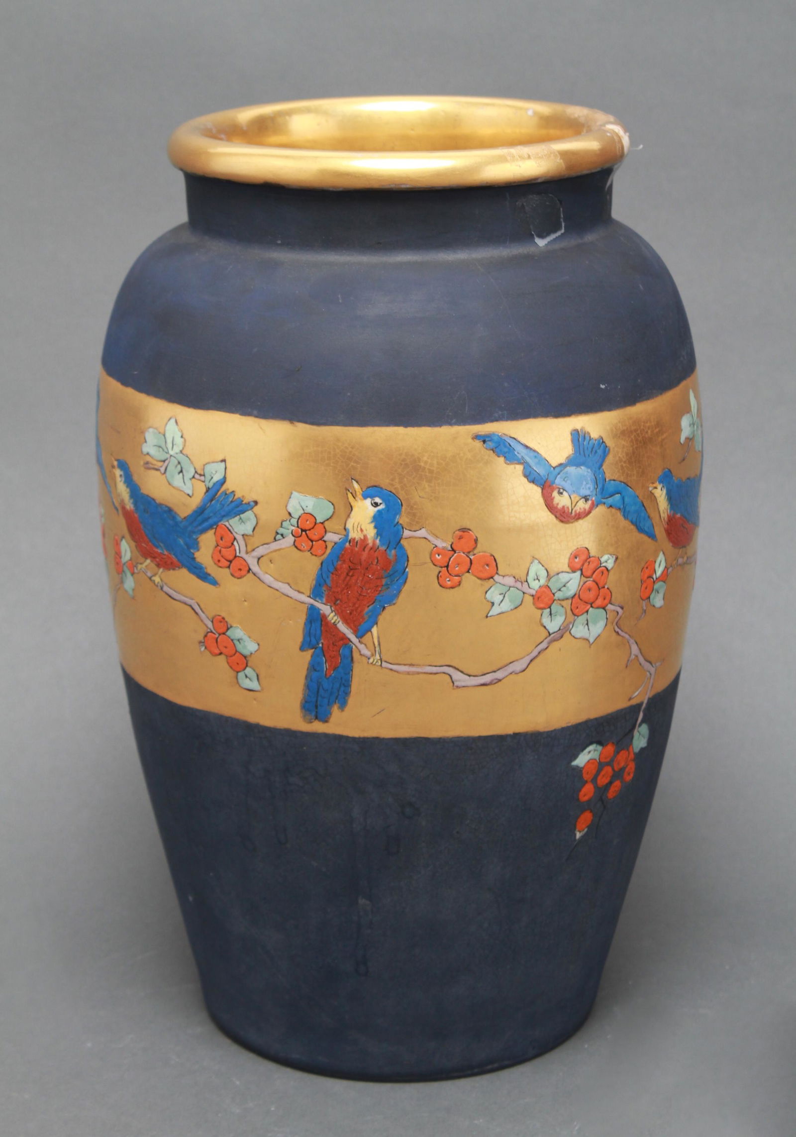 Ethel Smith "Birds and Holly" Pottery Vase: Pottery vase, dark blue ground with gilt rim and central band with birds and holly motif, signed underside: "Ethel Smith," and bearing impressed mark: "Japan." 12.25" H x 8" diameter. Crazing.