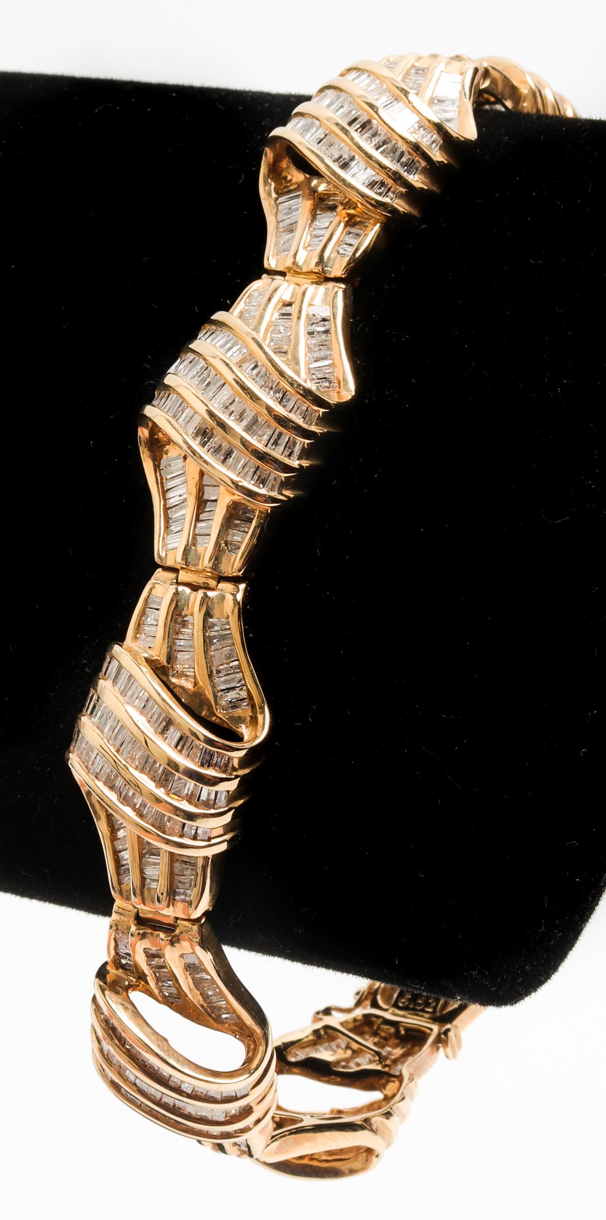 Vintage 14K Yellow Gold & Diamond Bracelet: Vintage 14K yellow gold diamond bracelet, approx: 742 baguette-cut diamonds, 6.52 ct tw., color: H-I, clarity: SI2-I1, marked: "14K / 6.52." 7.5" L x 0.5" W x 0.25" H. Approx: 18.6 dwt (inclusive)
