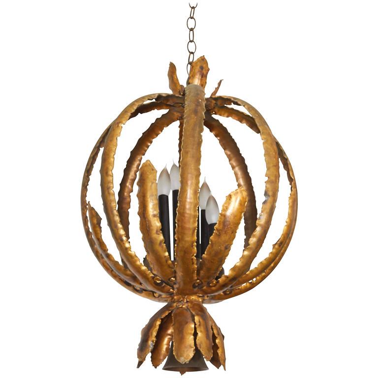 Tom Greene Feldman Brutalist Metal Chandelier: Tom Green for Feldman Brutalist chandelier, 1970s, sheets of torch cut and soldered enameled metal, formed into a pod shape, surrounding six staggered lights. 27" H x 18.5" diameter.