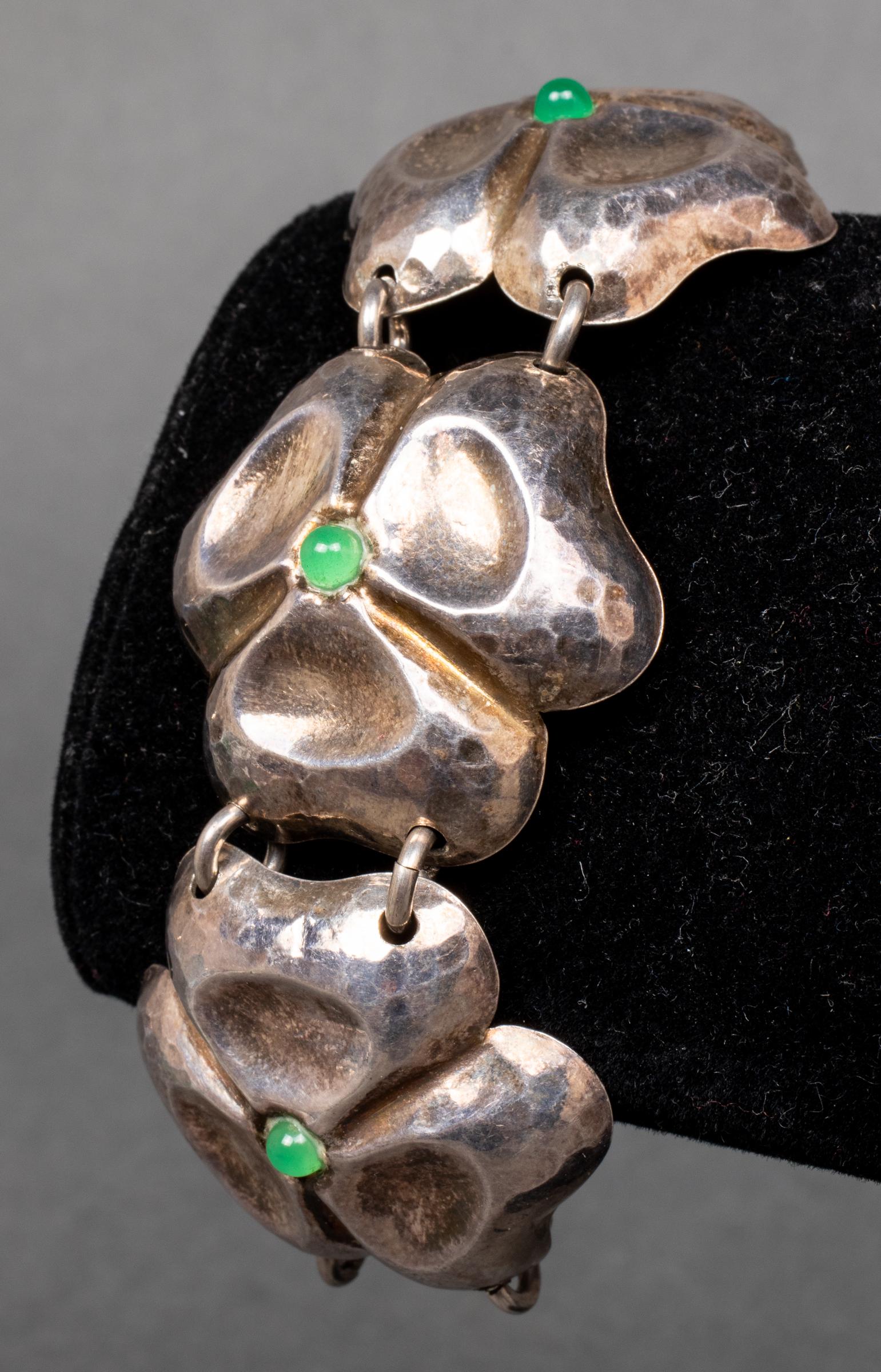 Scandinavian Silver & Green Stone Clover Bracelet: Scandinavian style silver and green stone clover motif bracelet, with five 4mm cabochon-cut green stones. 7.5" L x 1.375" W. Silver tested. Approx: 1.03 ozt inclusive.
