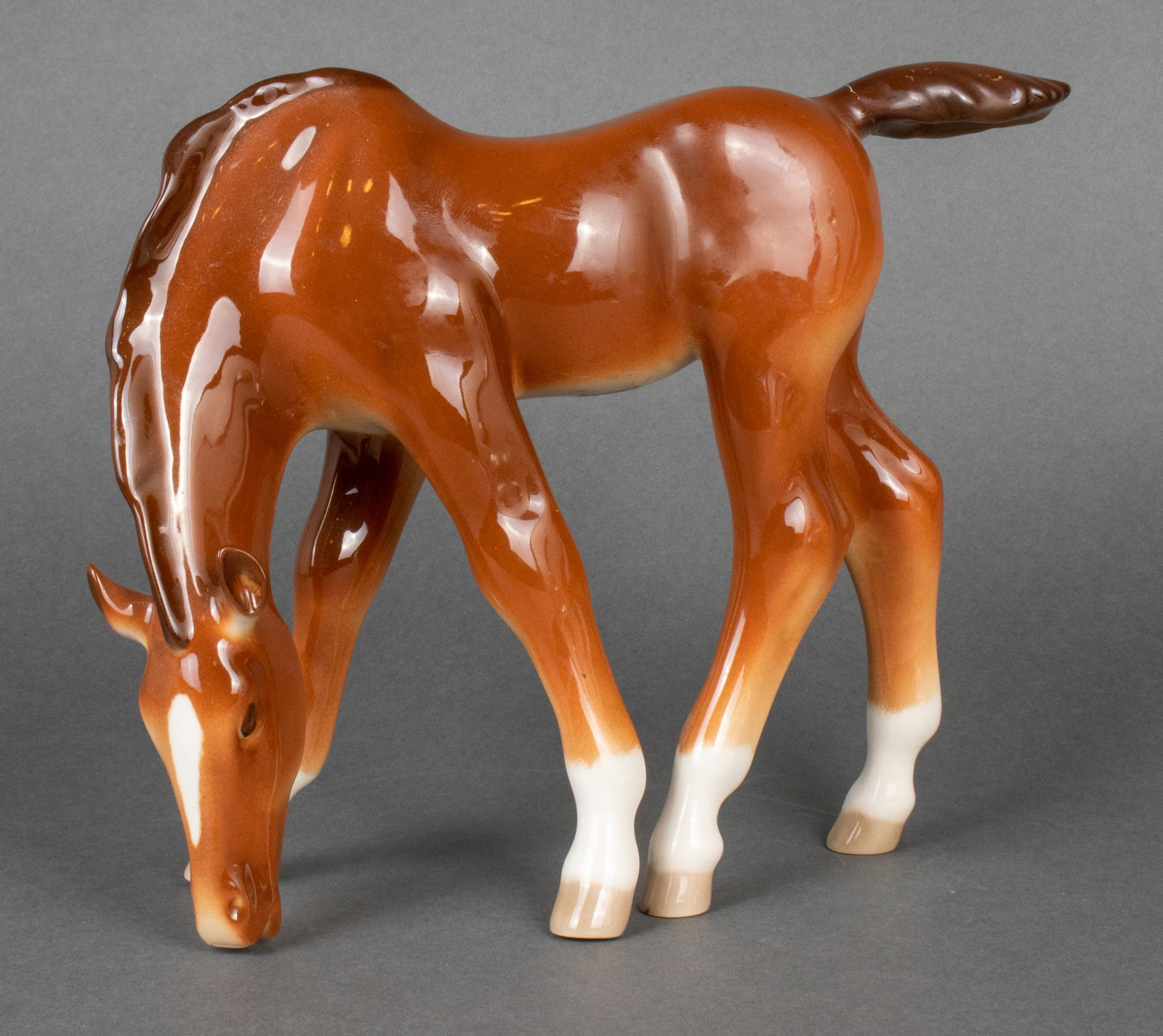 Lomonosov Russian Porcelain Drinking Colt Figurine: Lomonosov Russian porcelain figurine depicting a colt / horse drinking, bearing maker's mark to hoof underside. 8" H x 10" W. Repair to tail.