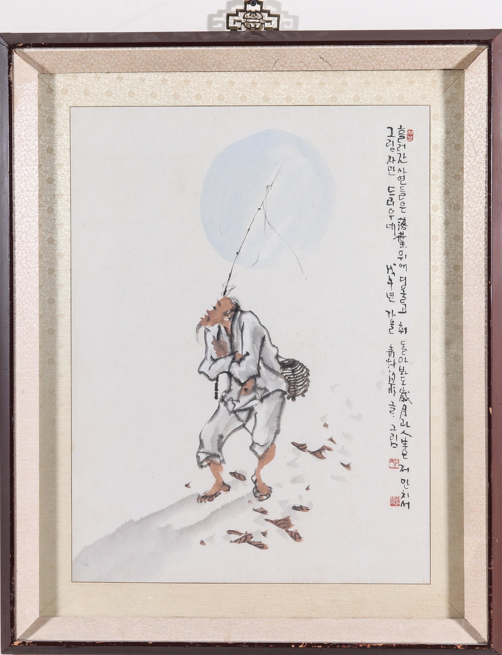 Korean Ink & Watercolor Painting of Male Figure: Korean ink and watercolor painting of a male figure and a pale blue moon with Korean calligraphy on the right side with chop seal, floral brocade border lining. Image: 27.5" H x 21.5" W; frame: 31.5" 