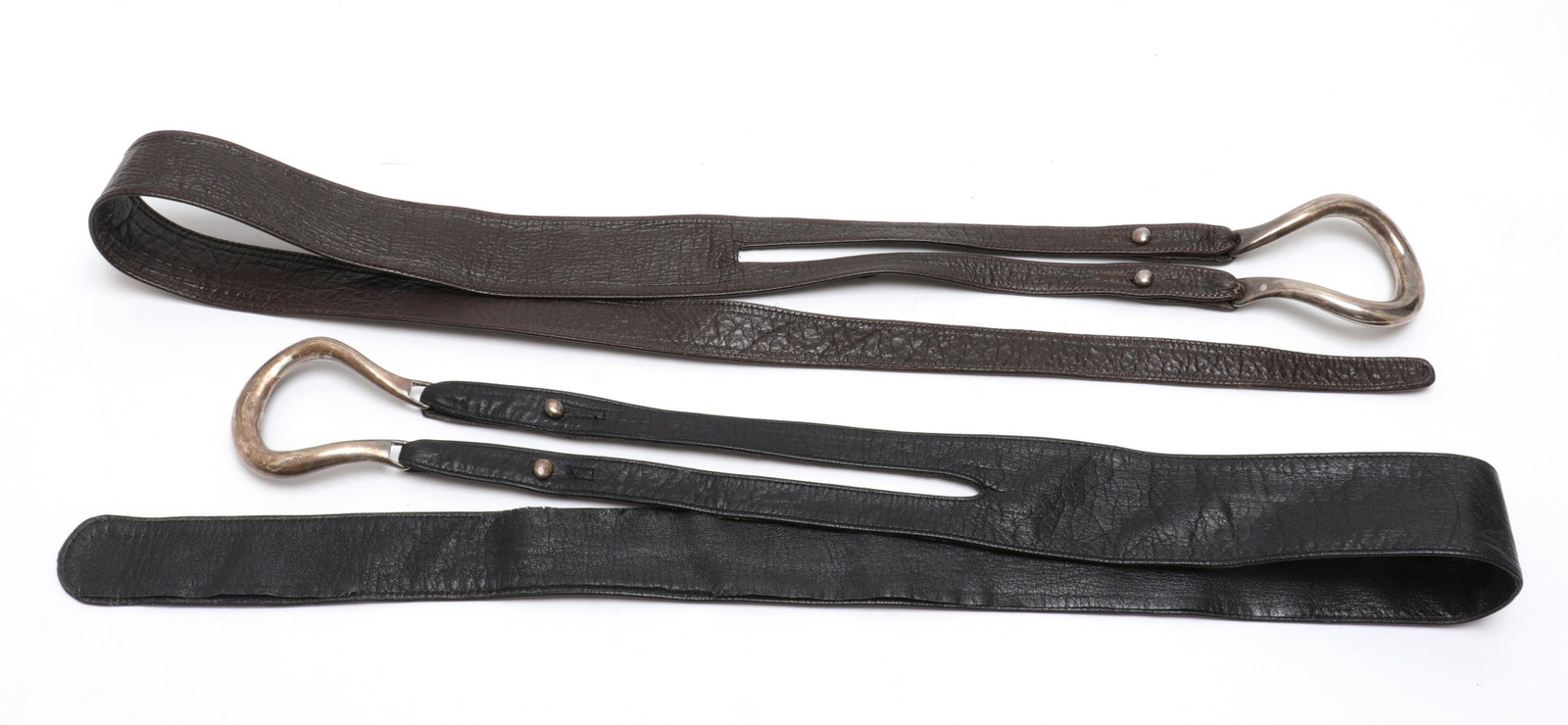 Peretti for Tiffany & Co. Sterling & Leather Belts: Two Elsa Peretti for Tiffany & Co. sterling silver and leather equestrian belts, one deep brown leather, the other black leather, with sterling horseshoe shaped buckles, the studs on one belt signed "