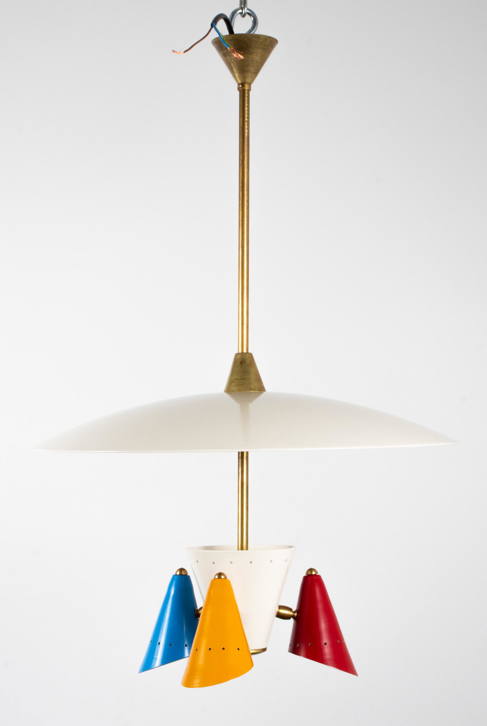 Italian Stilnovo Style Three-Light Chandelier: Italian Stilnovo style modern three-light chandelier / pendant light, round disc over three arms terminating in red, yellow, and blue perforated enameled metal shades. Approx: 30" H x 20.5" diameter.