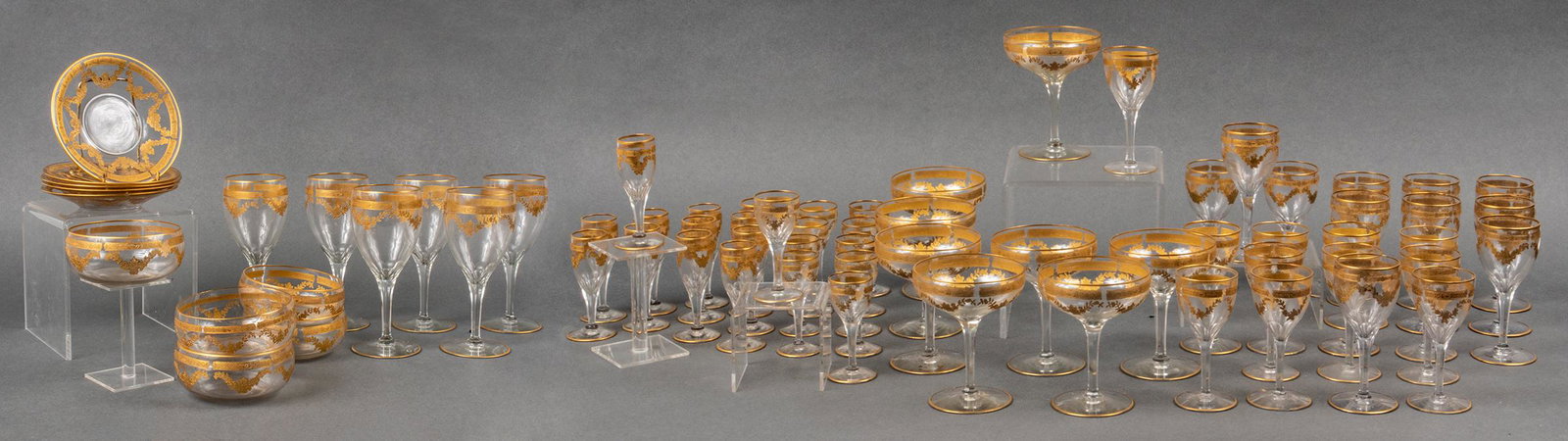 Gilt-Trimmed Glass Stemware, 67 Pieces: Large service of gilt-trimmed glass stemware with swag decoration, 67 pieces, comprising 6 wine glasses, 8 coupe glasses, 44 cordials in four respective sizes (including one complete set of 12, two se