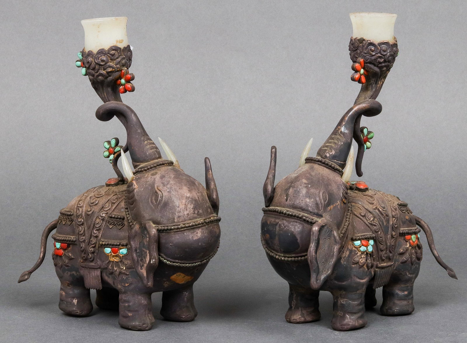 Antique Chinese-Tibetan Silver Elephants, Pair: Pair of antique Mongolian, or Tibetan, or Chinese Export silver and jade elephant-form altar candle holders inset with turquoise and coral, late 19th century. 7.5" H x 5.5" L x 2.5" D. Tested silver.