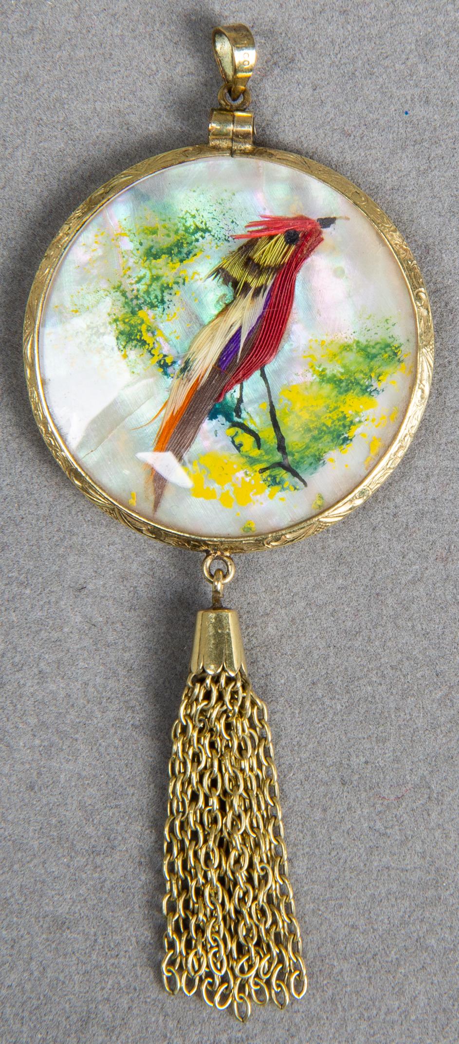 Victorian 14K Yellow Gold MOP Hand Painted Pendant: Victorian 14K yellow gold mother-of-pearl hand painted feather collage depicting birds at rest in foliage under glass in a conforming round engraved bezel with gold-tone tassel and bail, marked: "PAT.