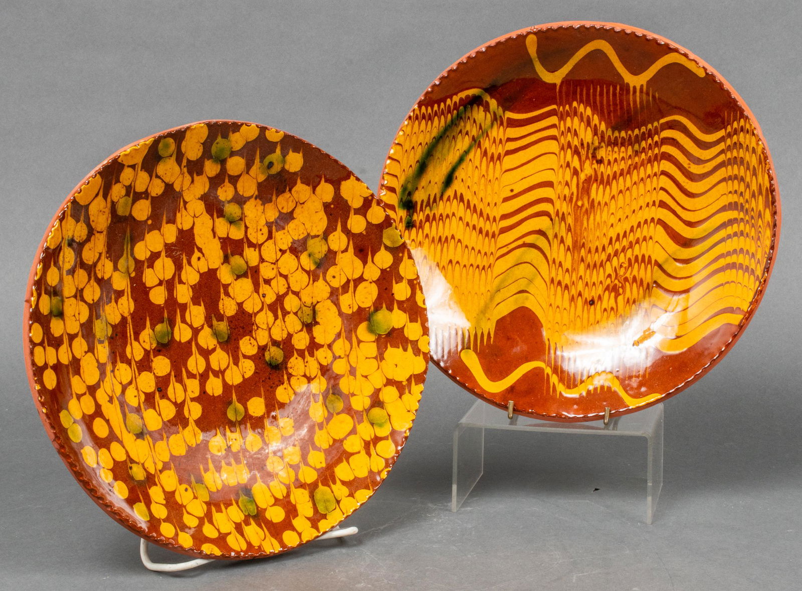 Lester Breininger Redware Art Pottery Plates, 2: Two Lester Breininger American art pottery plates, redware with red and yellow glaze, both signed on reverse and marked: "Robesonia, PA," one dated March 16, 1978 and titled: "Snowing," the other date