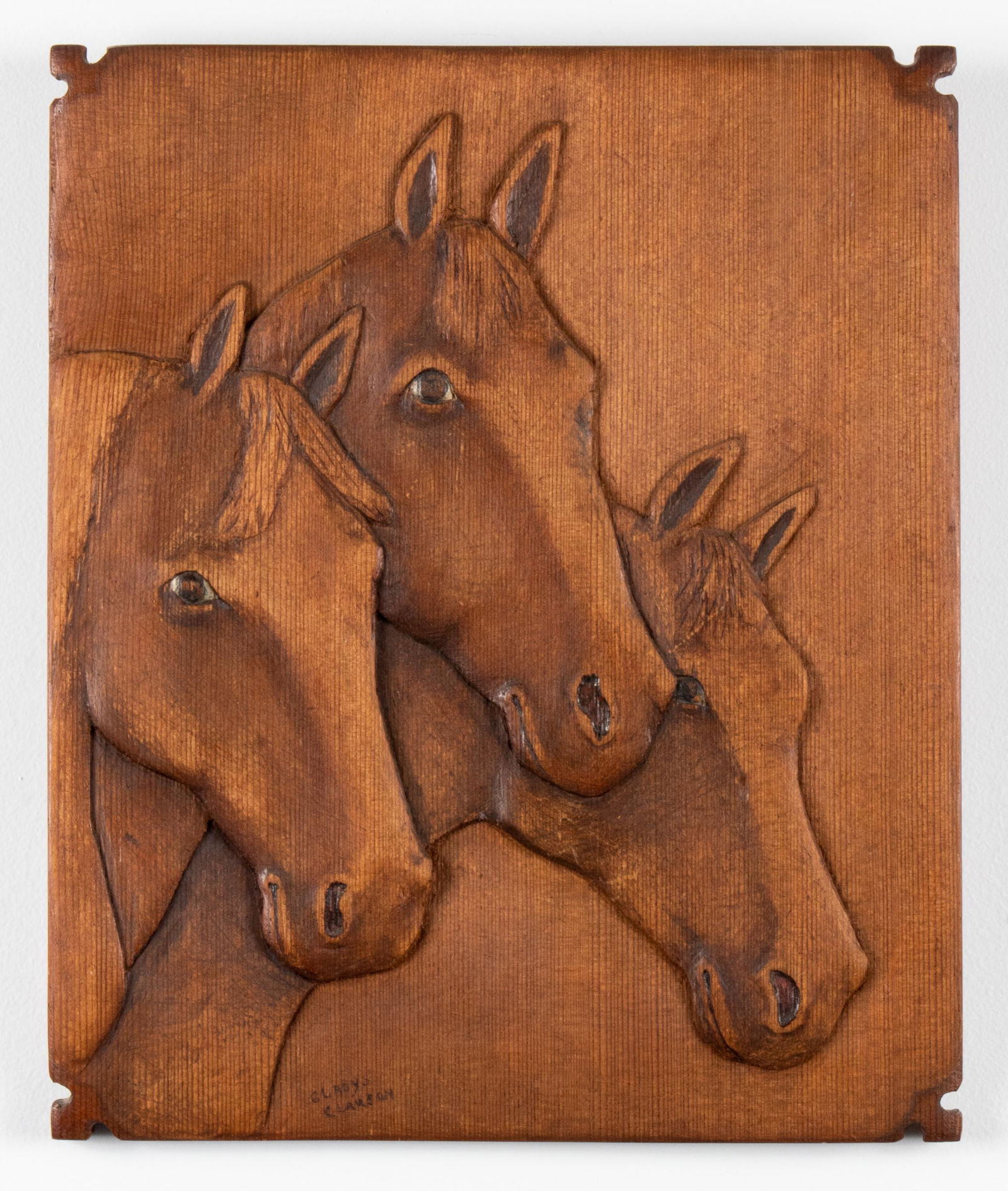 Gladys Clauson "Horses" Folk Art Wood Plaque: Gladys Clauson American Folk Art carved wood plaque depicting three horses in relief, signed at bottom: "Gladys Clauson," dated on reverse: "1941." 13.75" H x 11.25" W x 0.5" D.