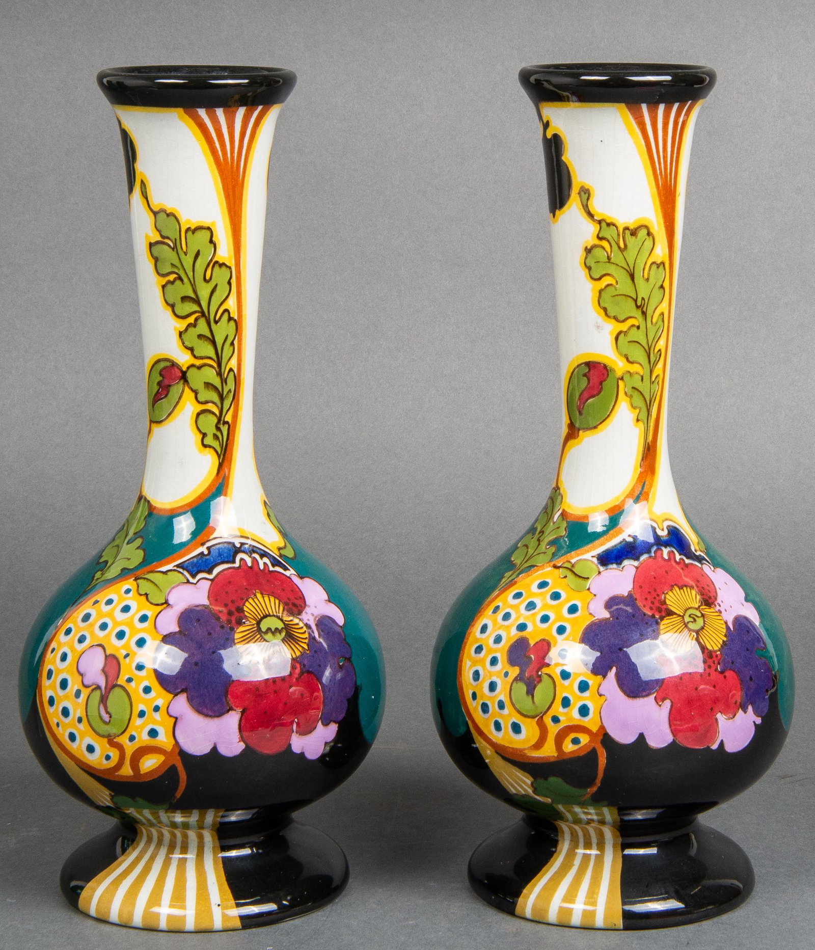 Gouda Pottery "Juliana" Ivora Earthenware Vase Pr: Pair of Dutch Gouda art pottery "Juliana" vases by Plateelfabriek Ivora, earthenware with polychrome glaze and floral motif decoration, marked underside: "218 Juliana Ivora Gouda Holland." 11.5" H x 5