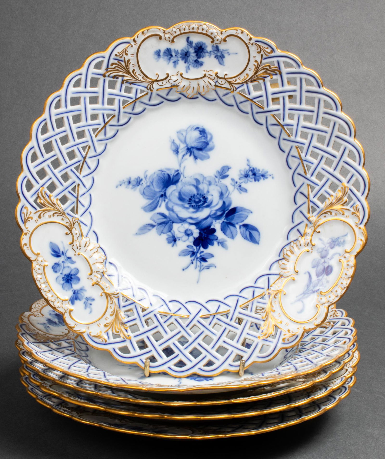 Meissen Reticulated Porcelain Plates, 5: Meissen blue and white porcelain luncheon plates with floral motif decoration and reticulated rims, blue underglaze crossed sword mark underside. 9.5" diameter.