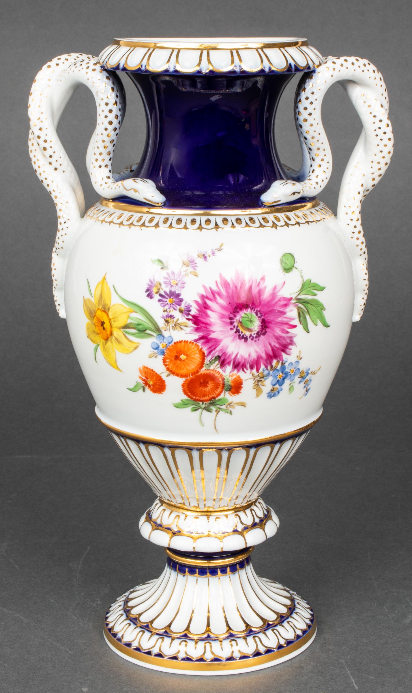 Meissen Porcelain Urn with Snake Motif Handles: Meissen German porcelain mantel urn with snake motif handles and hand-painted floral decoration, blue underglazed crossed swords mark underside. 10.5" H x 5" W.