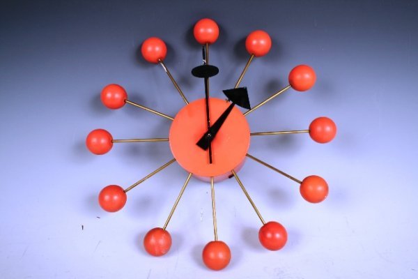 1950s Eames-Style Modernist Wall Clock: Eames-style electric wall clock from the 1950s with a rarely-seen salmon coloring.Dimensions: Approximately 13-1/4" diameterCondition: Untested, missing electrical cord; on body and hands, some soilin