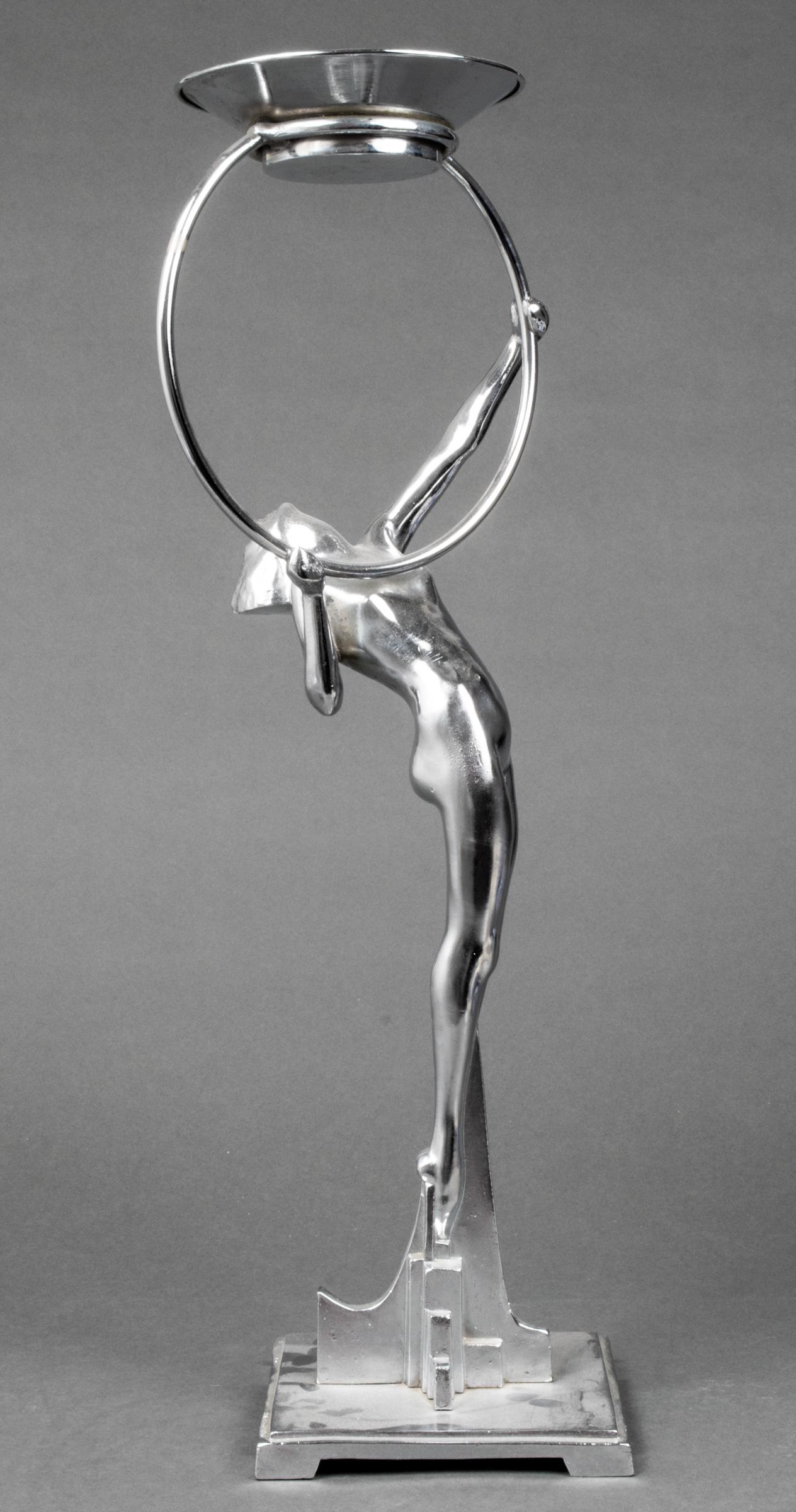 Art Deco Figural Cast Metal Card Holder Stand: Art Deco cast metal card holder or ashtray stand, chromed finish, depicting female nude holding ring supporting a round dish, geometric base. 26" H; base: 6.5" square.